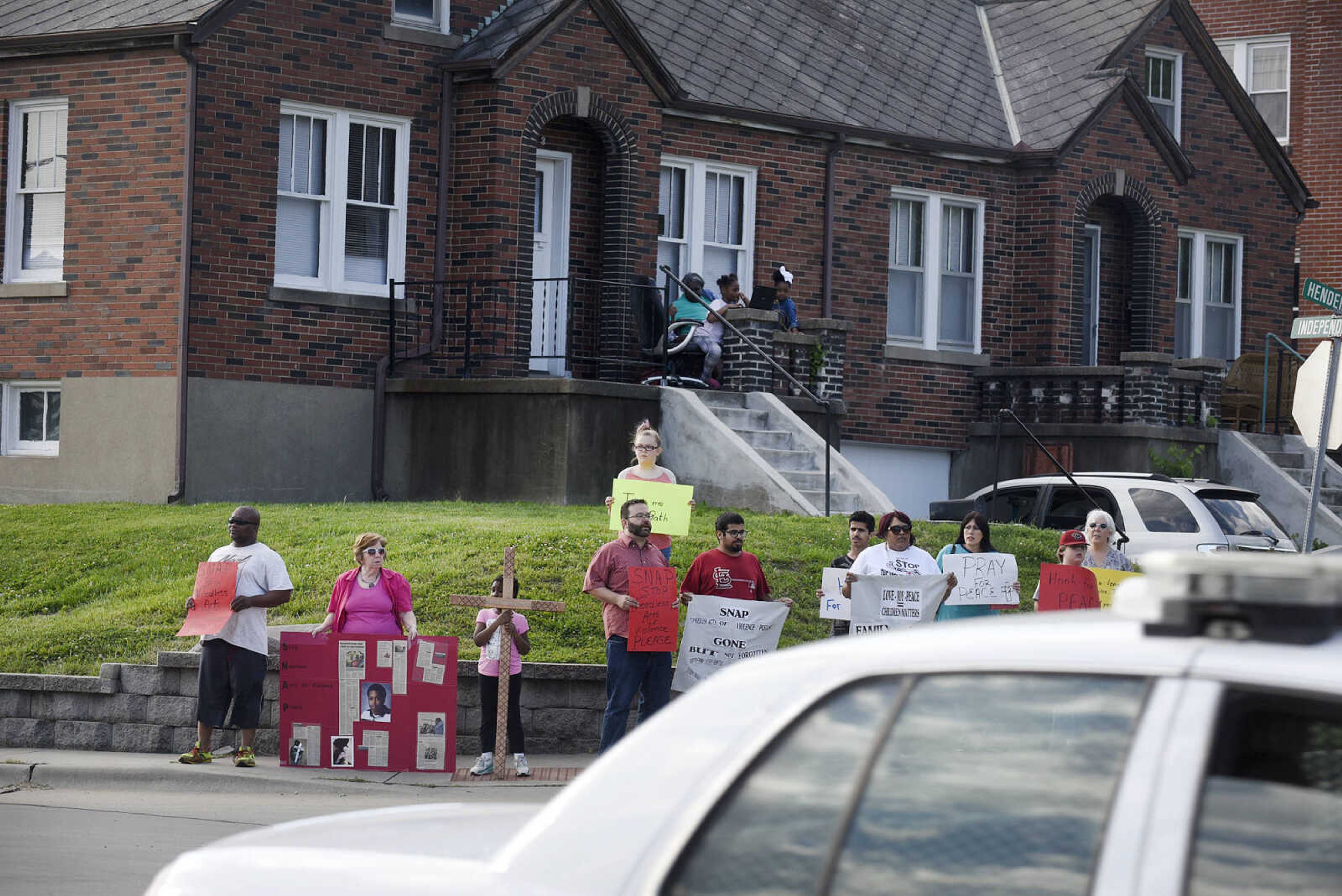 Community members join together in prayer during a Stop Needless Acts of Violence Please(SNAP) community prayer on Tuesday, May 16, 2017, at the corner of Independence Street and Henderson Ave. in Cape Girardeau.