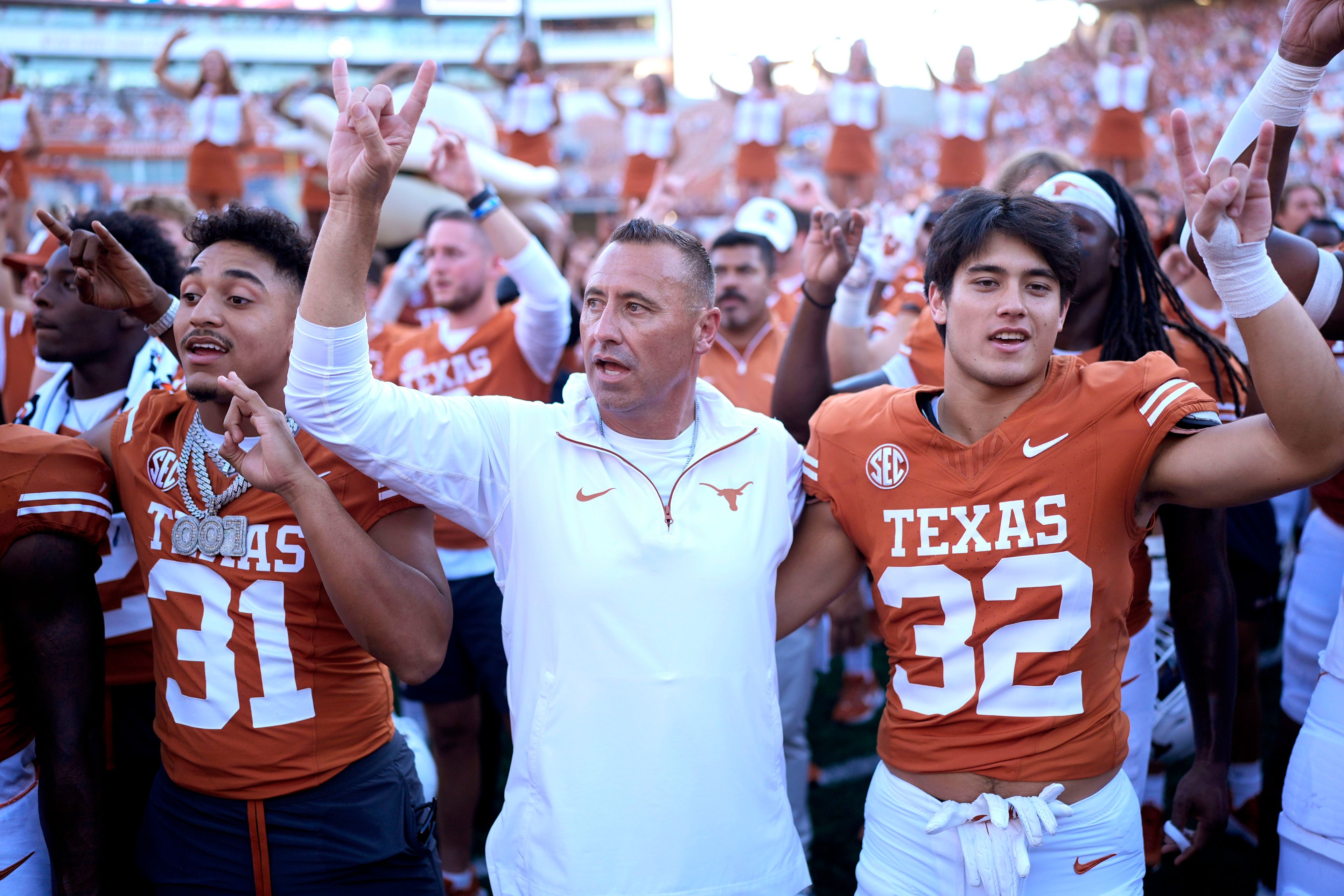 Texas head coach Steve Sarkisian, center, joins players for the school song following their win over Mississippi State in an NCAA college football game in Austin, Texas, Saturday, Sept. 28, 2024. (AP Photo/Eric Gay)