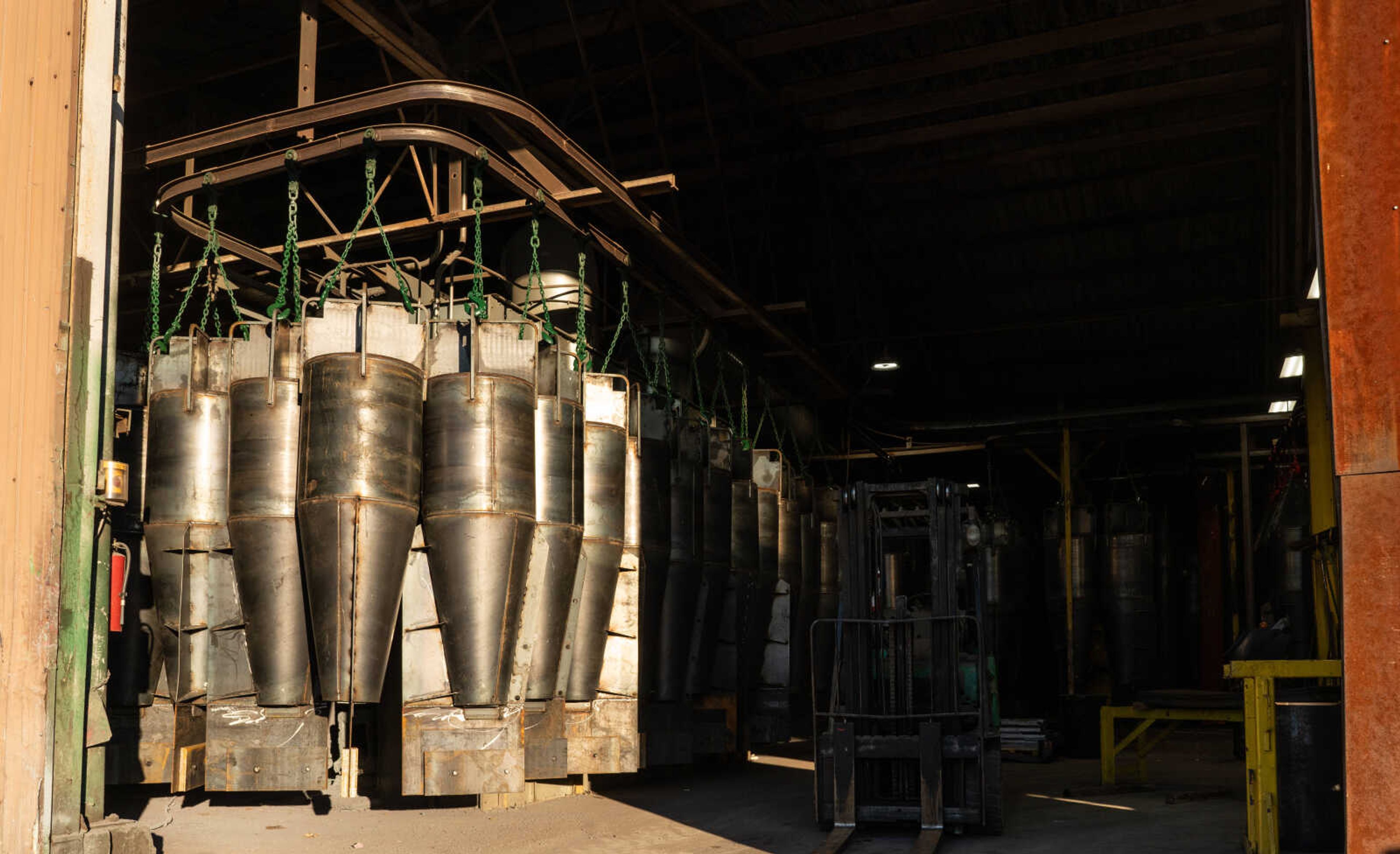 Buoys hang from a track, awaiting a coating of marine-grade paint at H&G Marine in Perryville. The manufacturer produces 4th class and 6th class fresh water buoys. 
