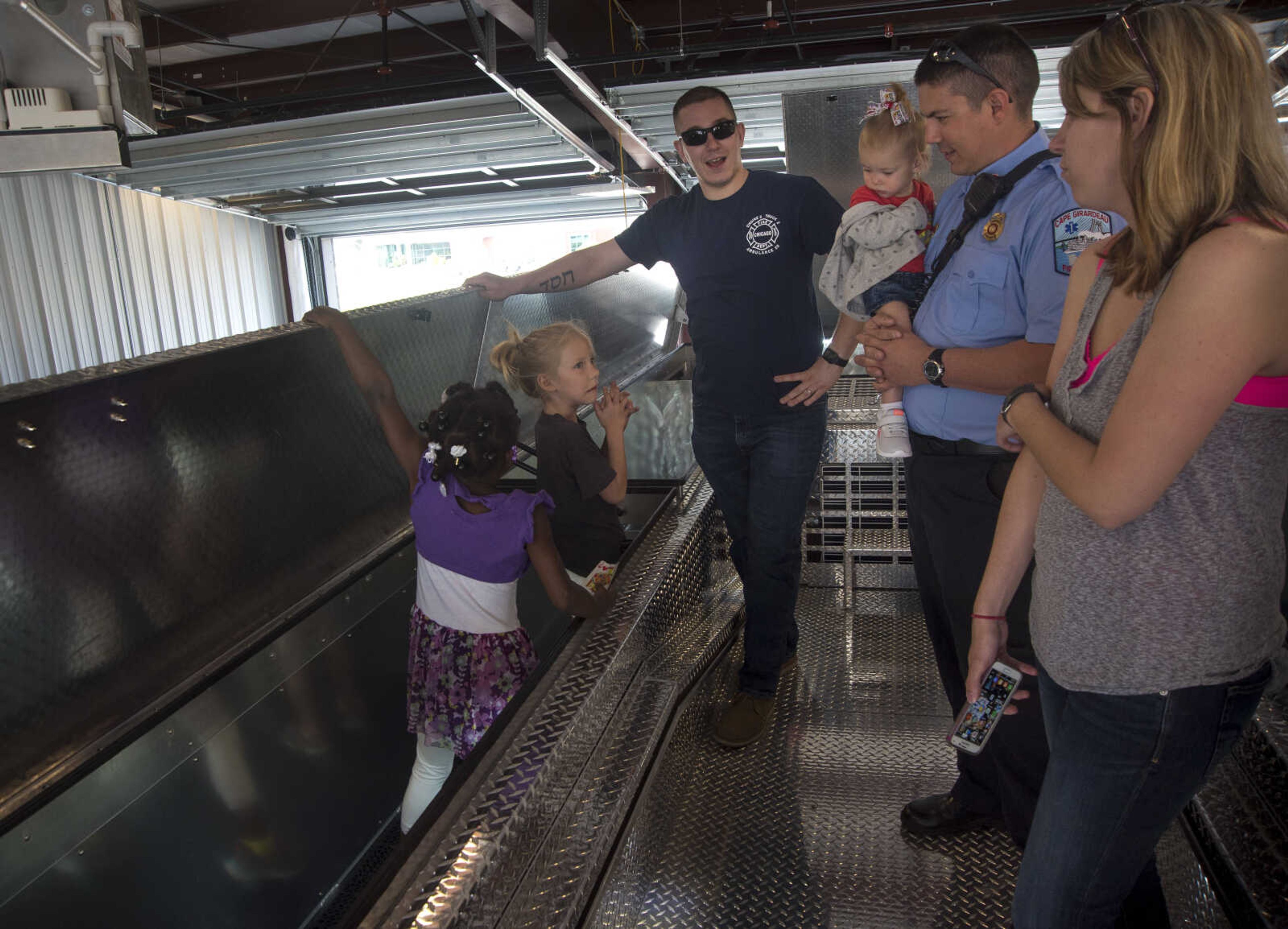 People view new fire trucks during the showing of the six Cape Girardeau fire trucks purchased at fire station number two Saturday, April 15, 2017 in Cape Girardeau. The National Fire Protection Association recommends fire departments to rotate their fleet every 10 years costing approximately $3.8 million dollars.