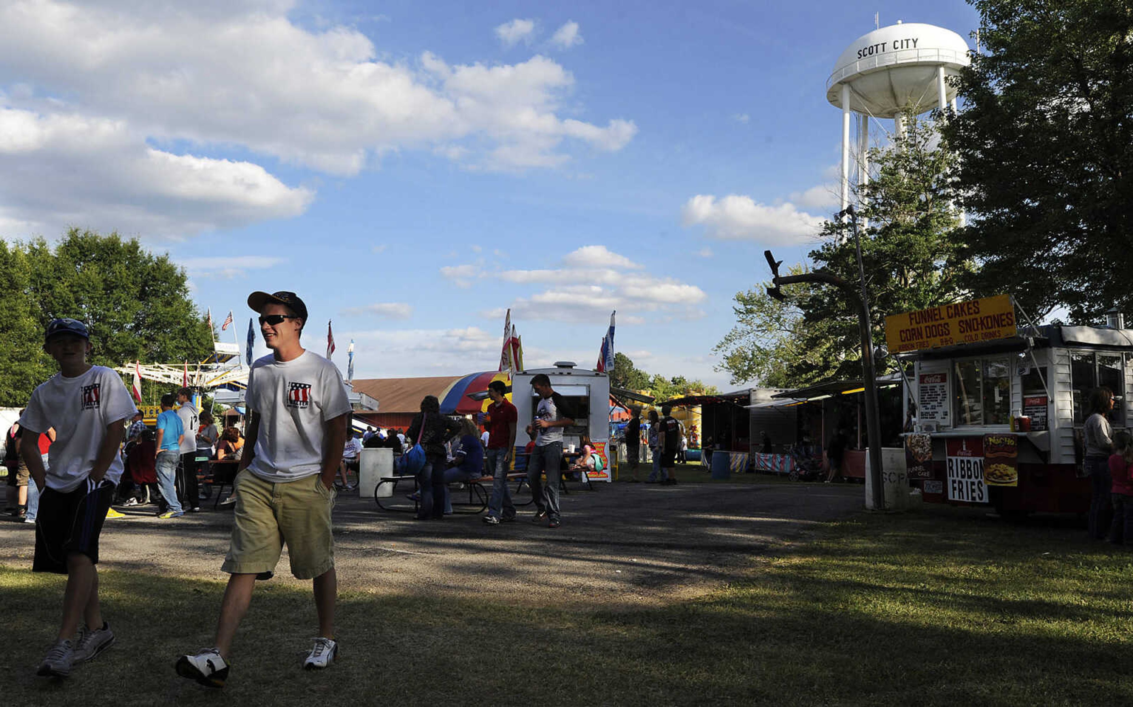 Attendees walk through the fair grounds at the 36th annual Scott City Summerfest Friday, June 1, at Scott City Park.