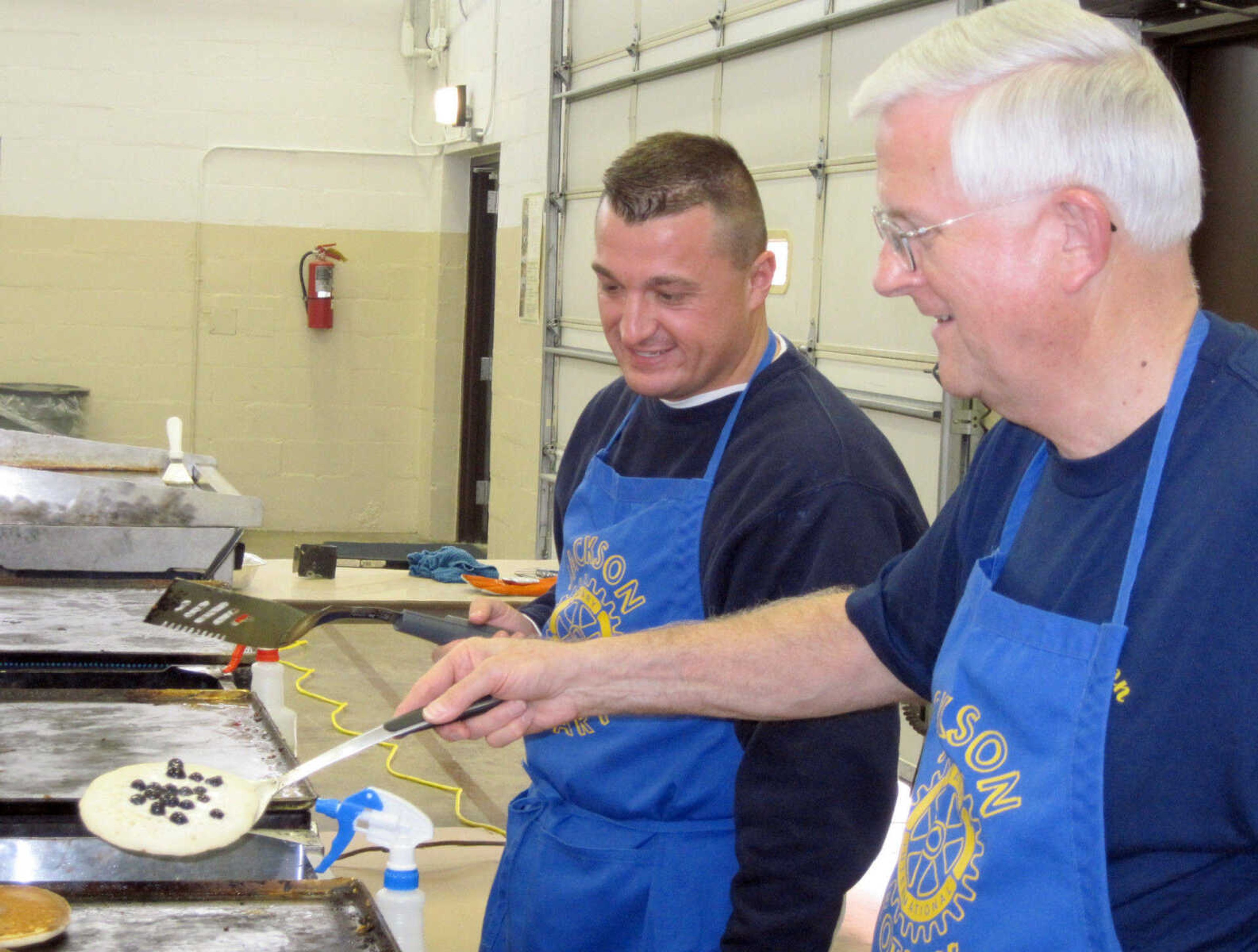 Rotary volunteers Brian Gerau, left, and Ron Hahs cook the food for Pancake Day.