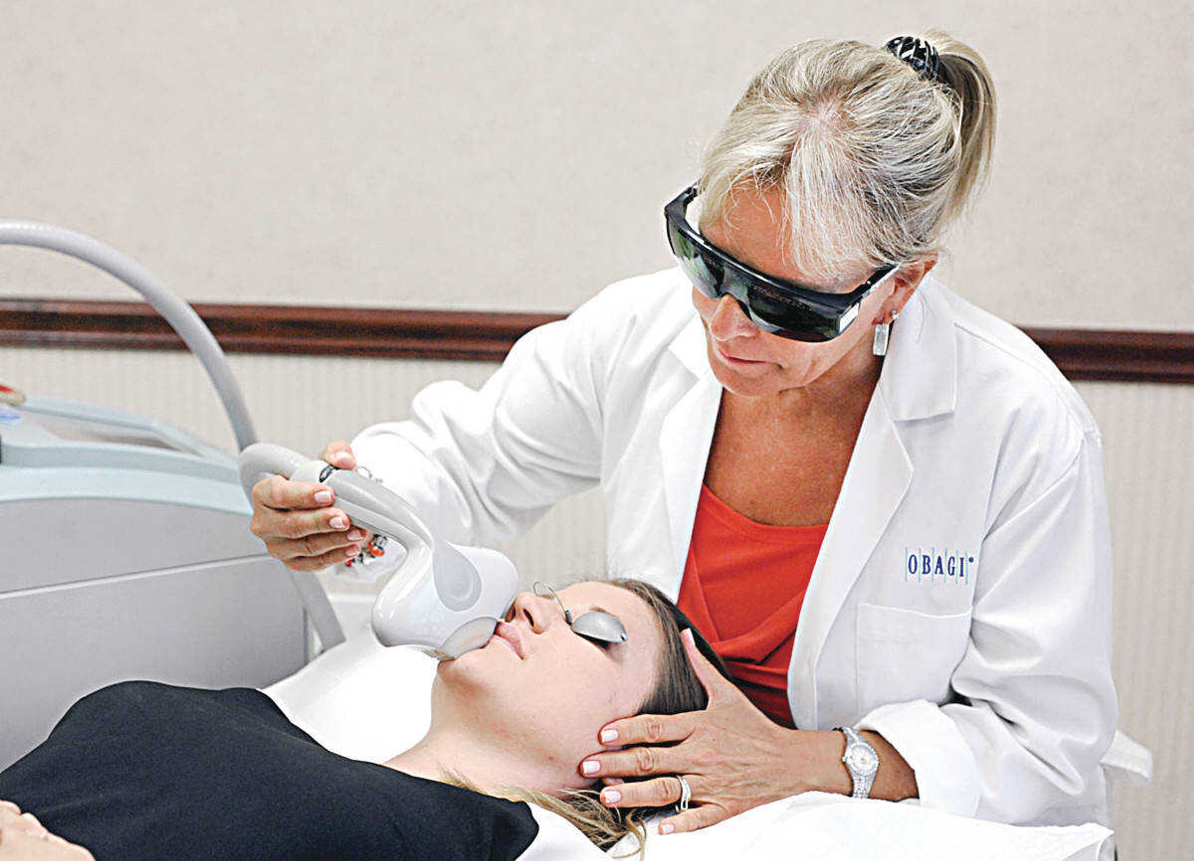 Pam Strauss, LPN at Heartland Plastic & Hand Surgery in Cape Girardeau, demonstrates the Laser Genesis with IPL treatment. (Laura Simon)