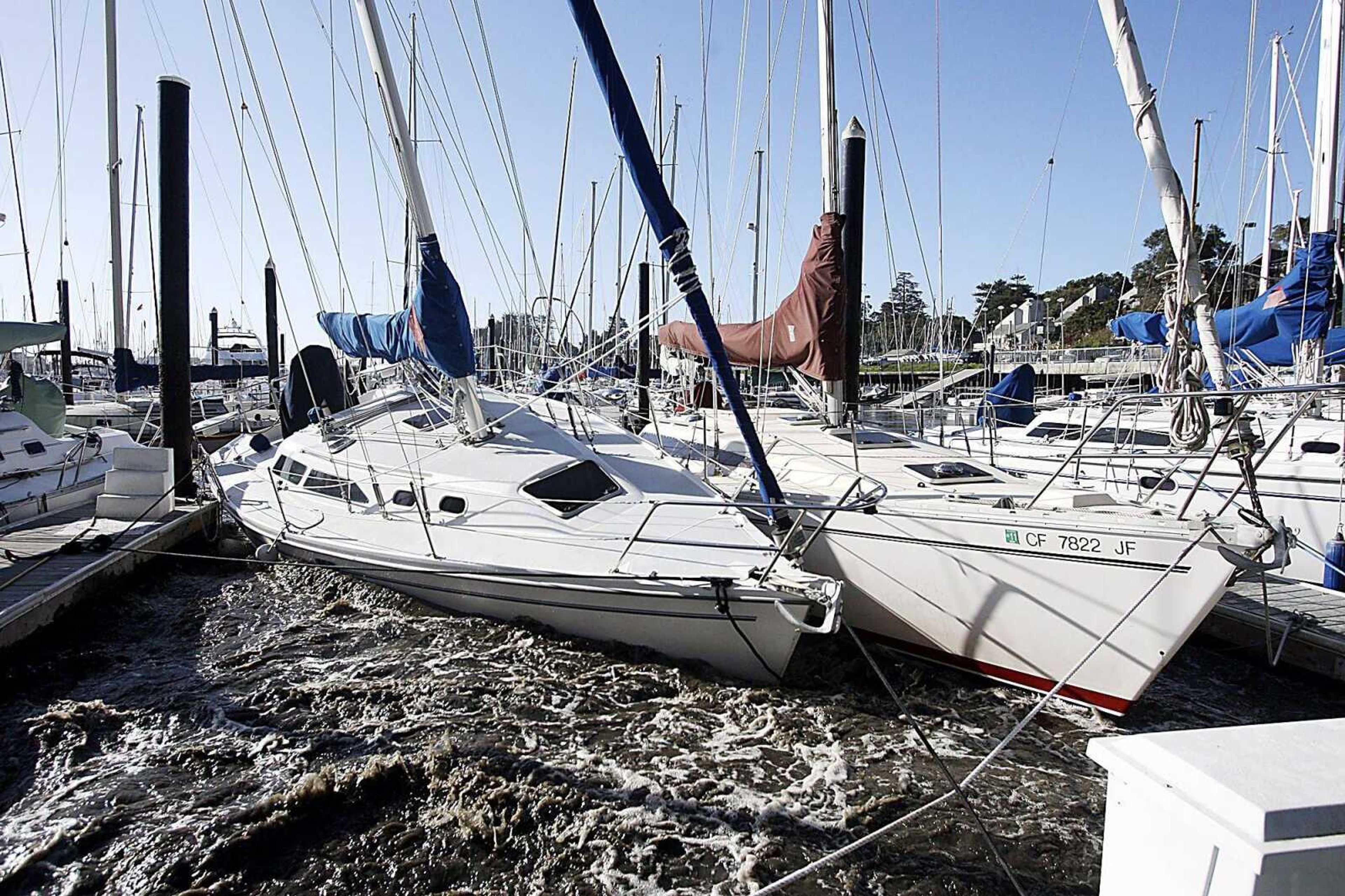 Sailboats in the Santa Cruz Harbor crash against each other Friday , March 11, 2011 in Santa Cruz, Calif. A tsunami triggered by the massive earthquake in Japan rushed onto California's coast Friday, causing powerful surges that destroyed boat docks as beach-area residents throughout the state evacuated to higher ground.  (AP Photo/Santa Cruz Sentinel, Dan Coyro)