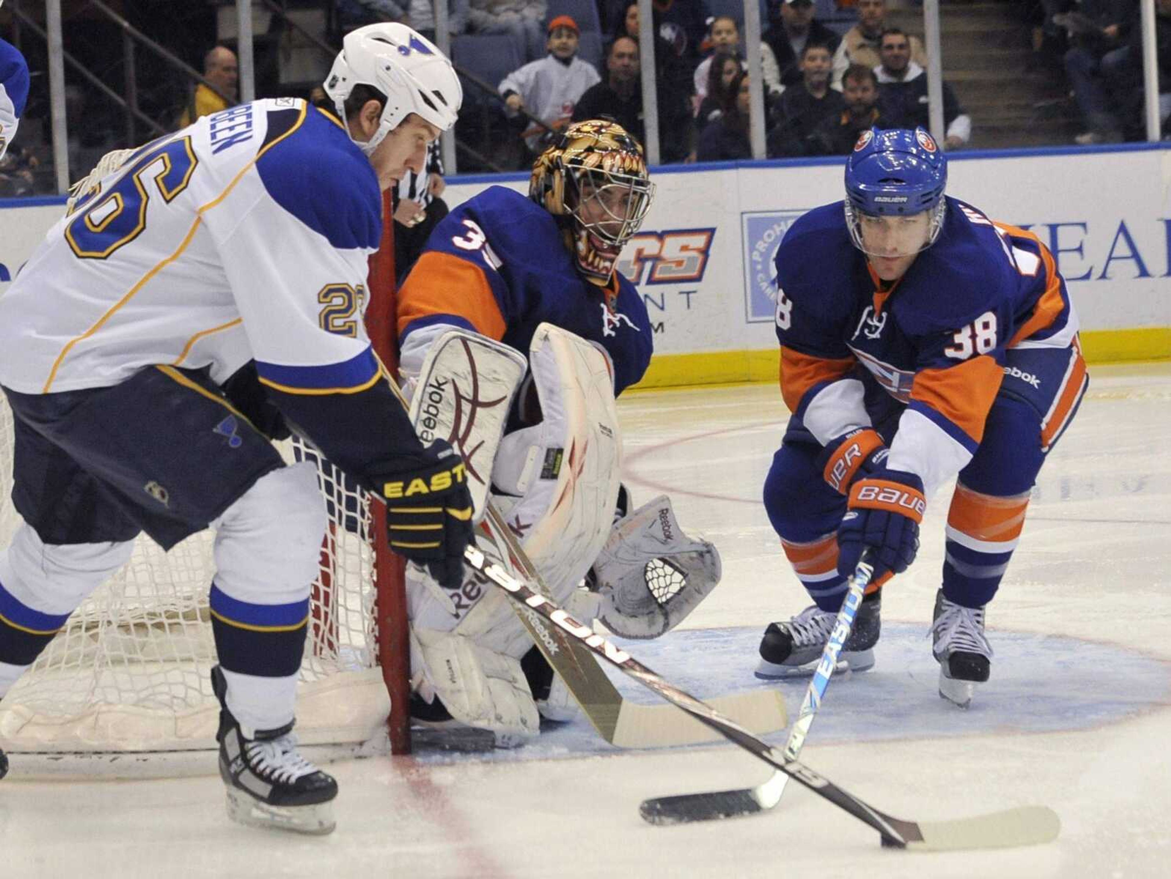 Islanders goalie Al Montoya and defenseman Jack Hillen watch Blues forward B.J. Crombeen during the first period Saturday. The Islanders won 5-2.