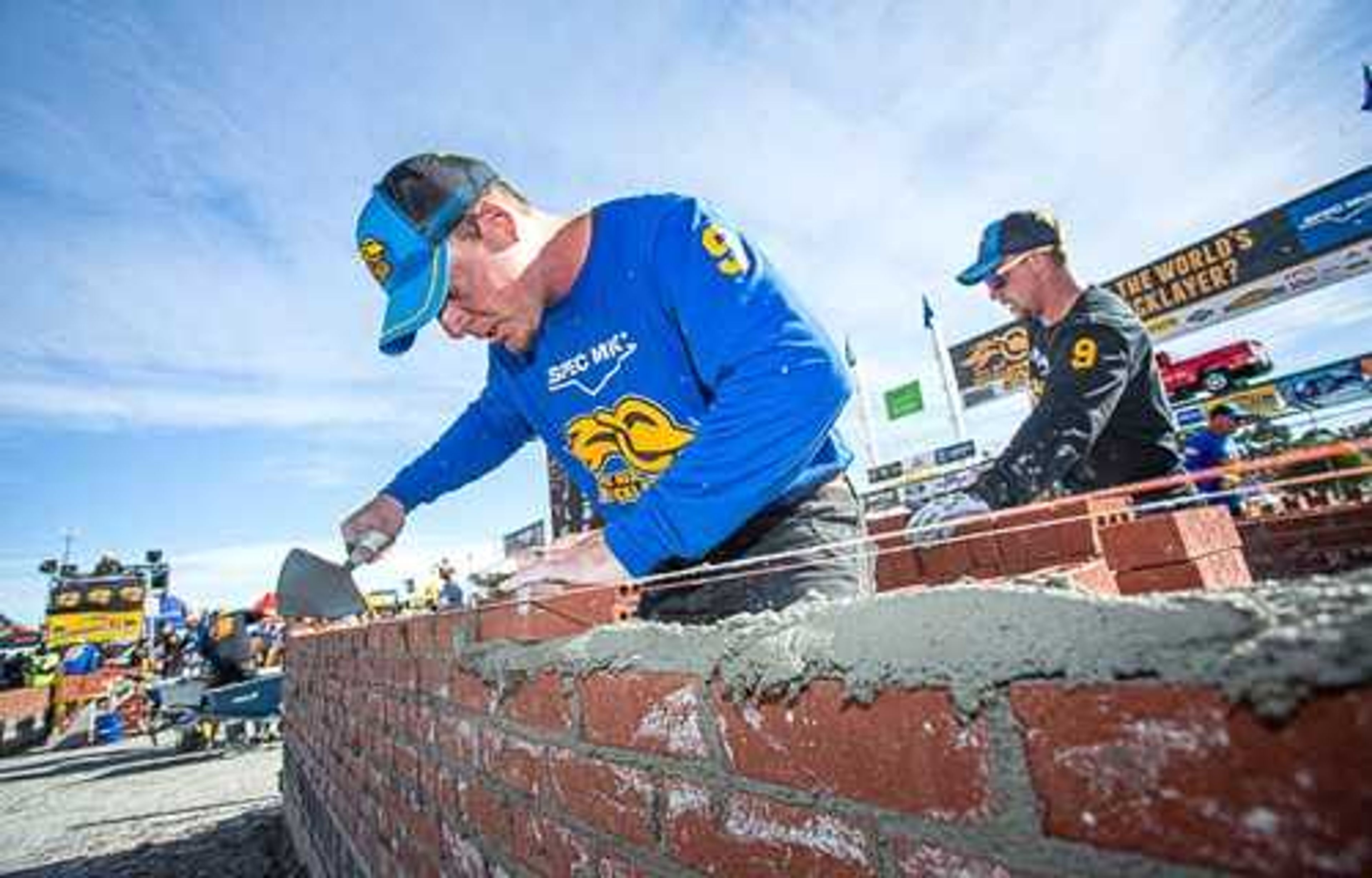 J.T. Payne of Jackson, in the foreground, lays a row of bricks during the 18th annual Bricklayer 500 competition Wednesday in Las Vegas. In the background is his brother, Jake Payne, who tendered bricks to him. "Team Payne" finished ninth  among more than two dozen teams in the national competition.