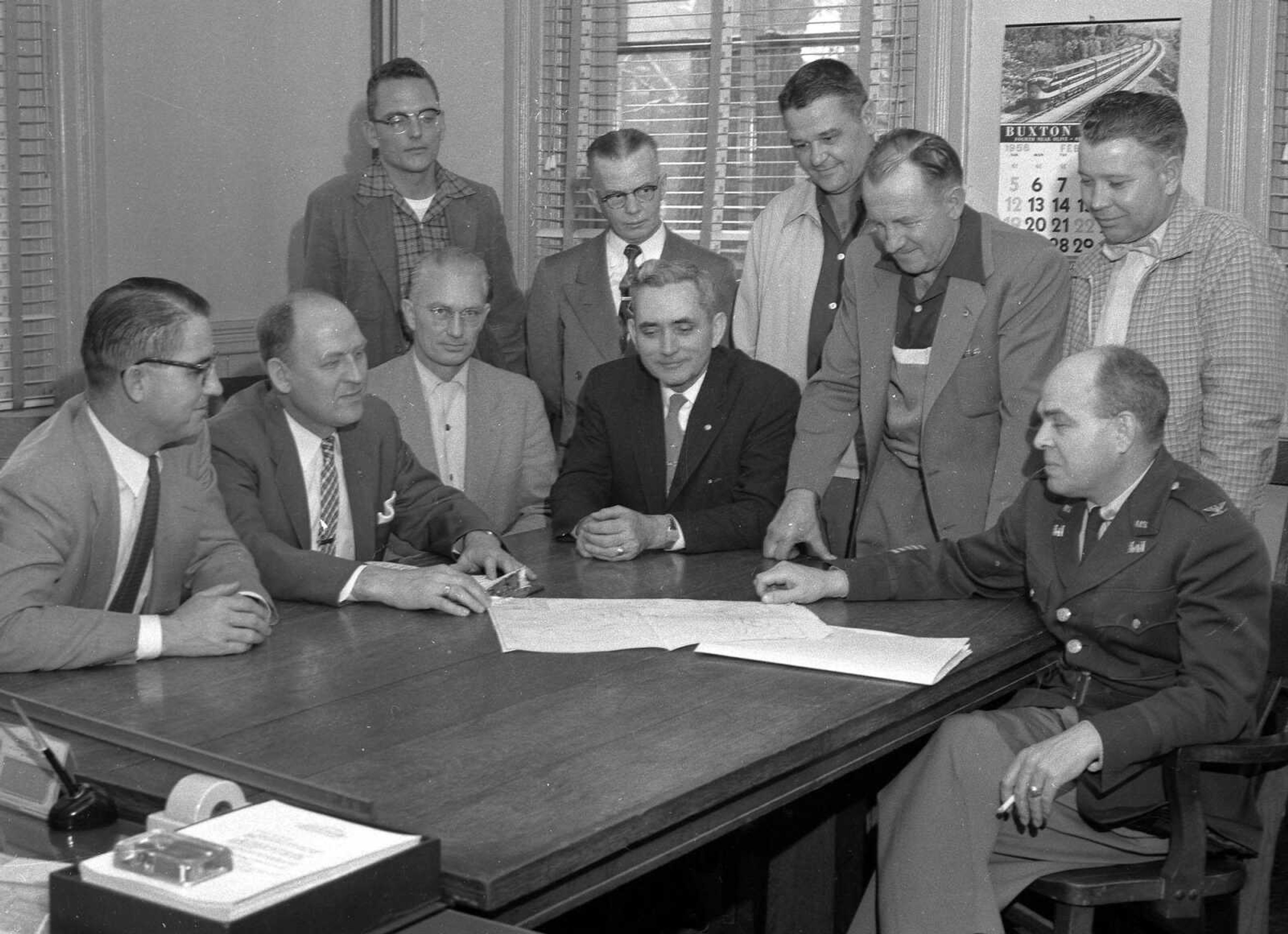 An Army Corps of Engineers officer appears to be consulting with members of the Cape Girardeau City Council. Perhaps they were discussing construction of the river floodwall. Gerald Johnson wrote: "Pic No. 7 is a repeat. Seated at left is Gerald Rowan, lawyer. Seated next is Norval Randol. Seated in center in black suit is U.G. Pettigrew."