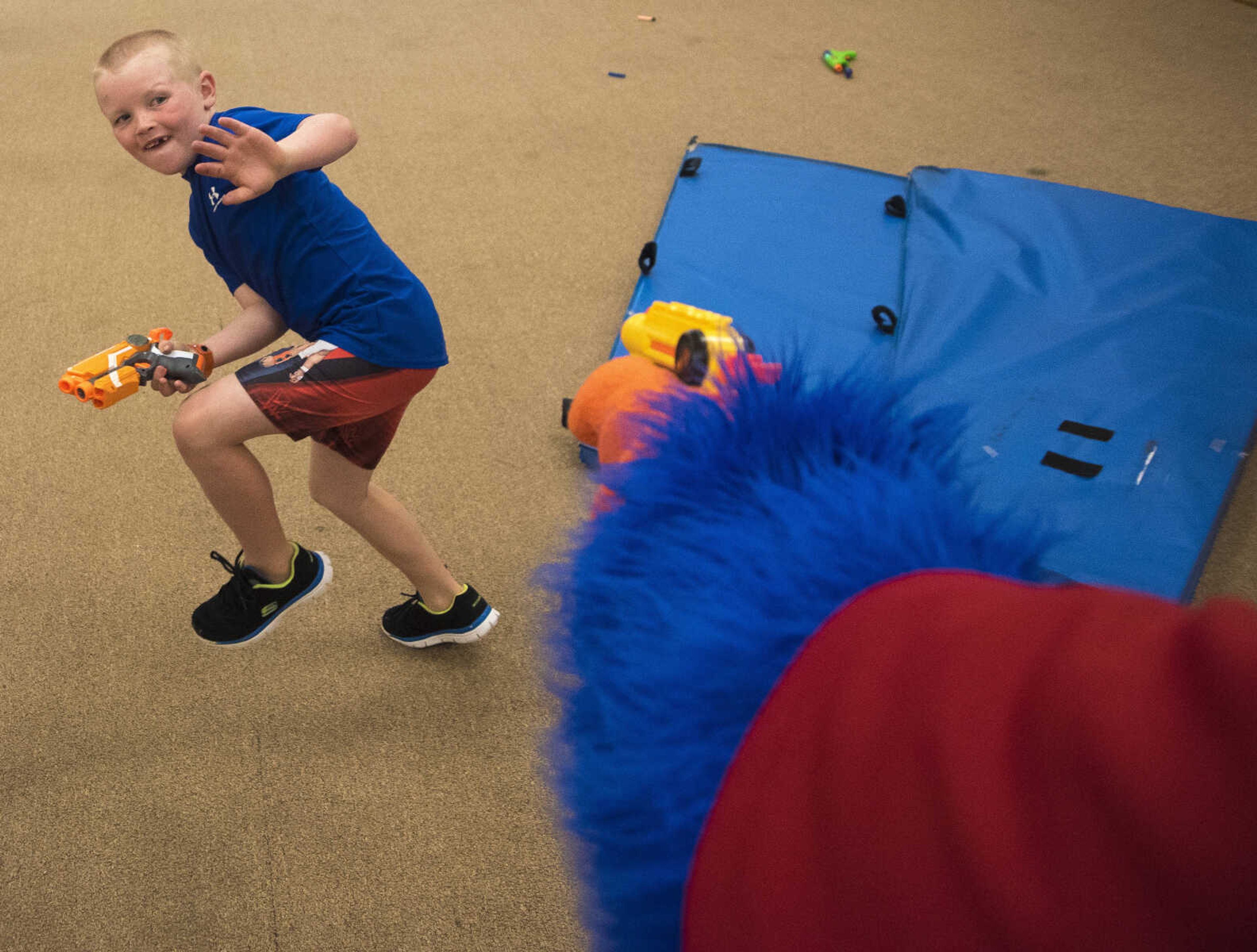 Hayden Swain, 7, blocks himself from a nerd dart shot by mascot Playmo during the Parks and Rec Day Friday, July 7, 2017 at the Osage Centre in Cape Girardeau.