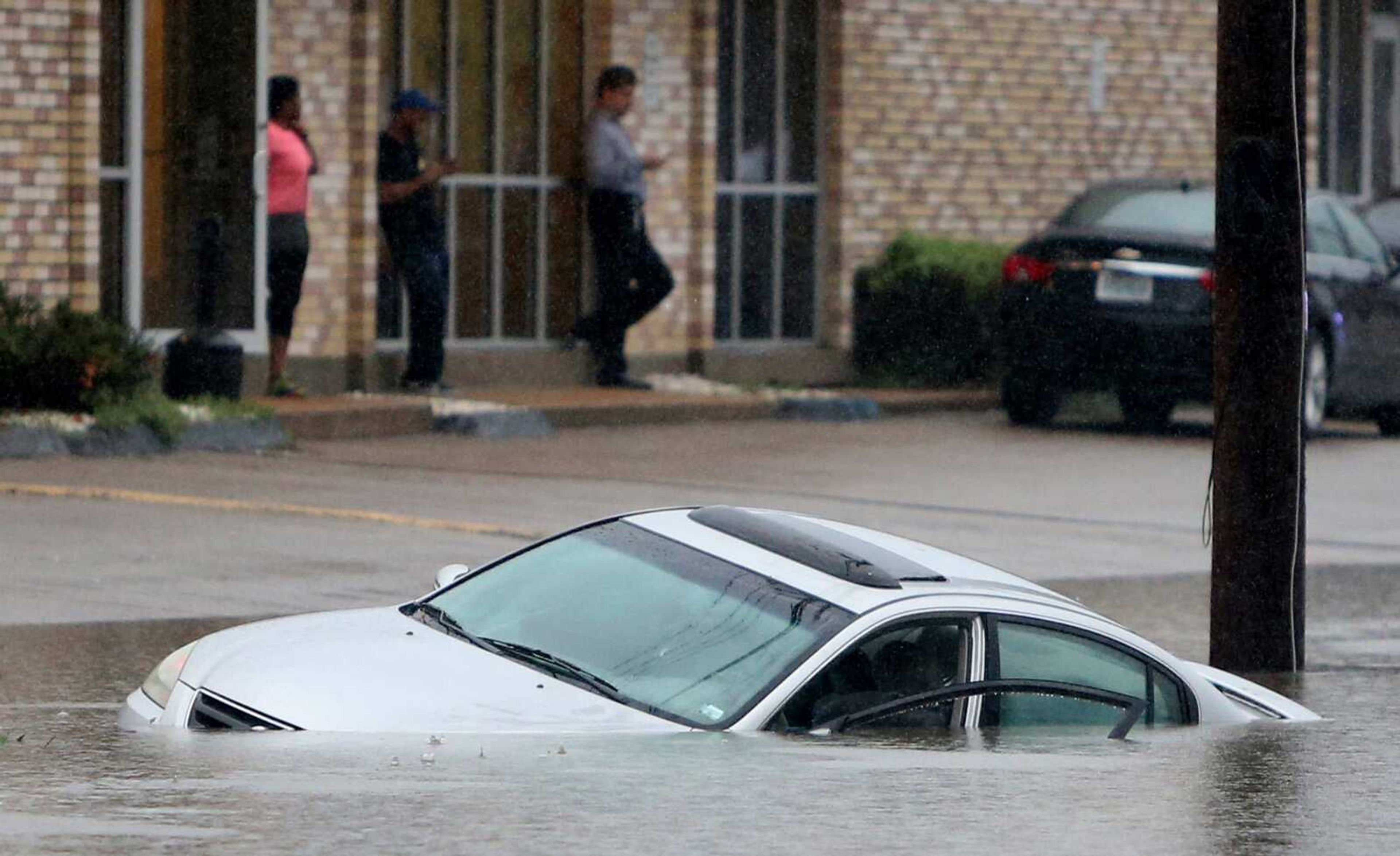 A car is stuck Monday in floodwater over South Hanley Road just north of Manchester Road in Brentwood, Missouri. The driver escaped safely. More than 7 inches of rain in parts of Missouri led to scattered evacuations, power outages and flood warnings.