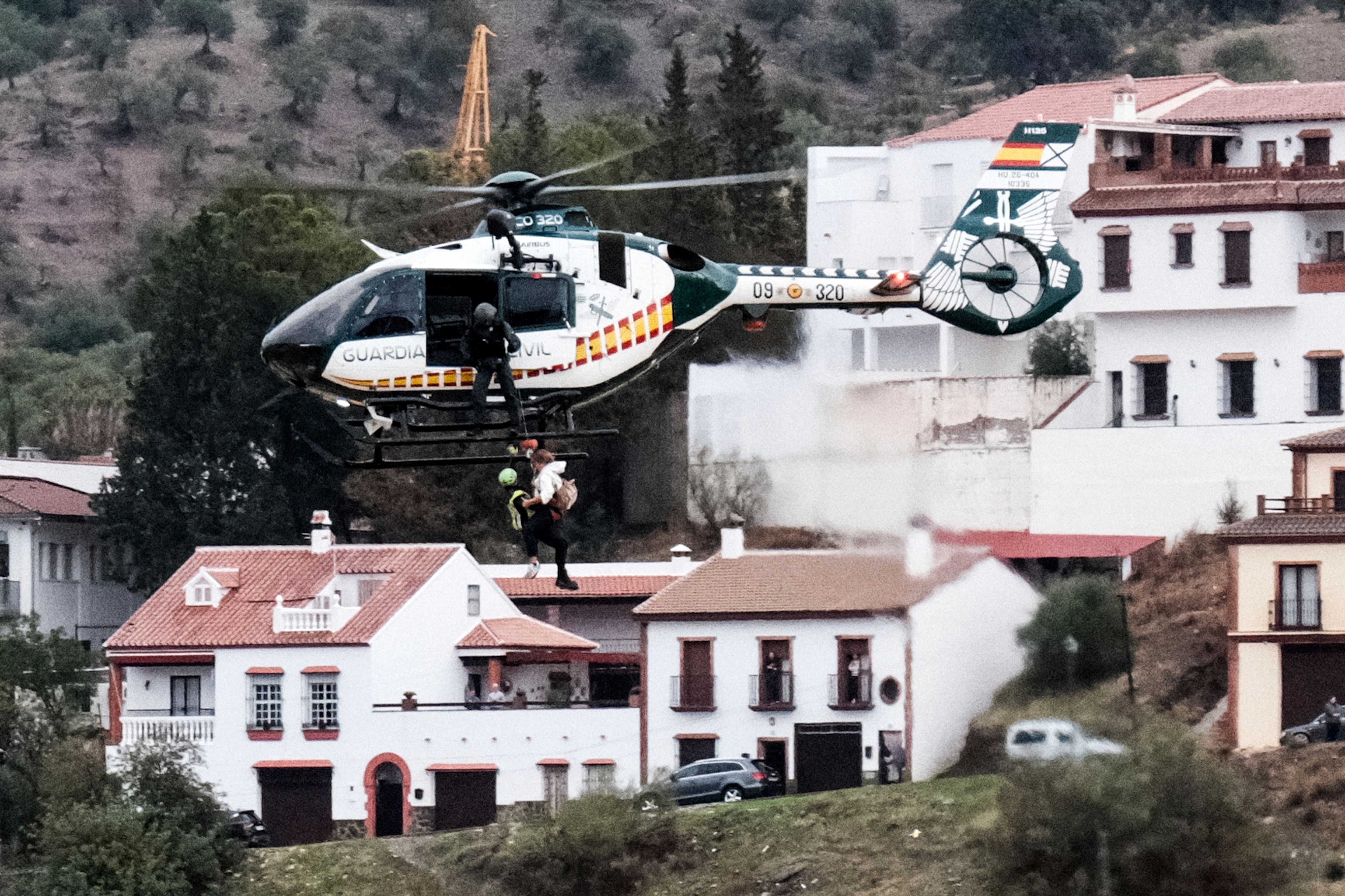 Emergency teams rescue a person who was stranded by the water in a Guardia Civil helicopter, after the floods preceded by heavy rains that caused the overflow of the river in the town of Alora, Malaga, Spain, Tuesday, Oct. 29, 2024. (AP Photo/Gregorio Marrero)