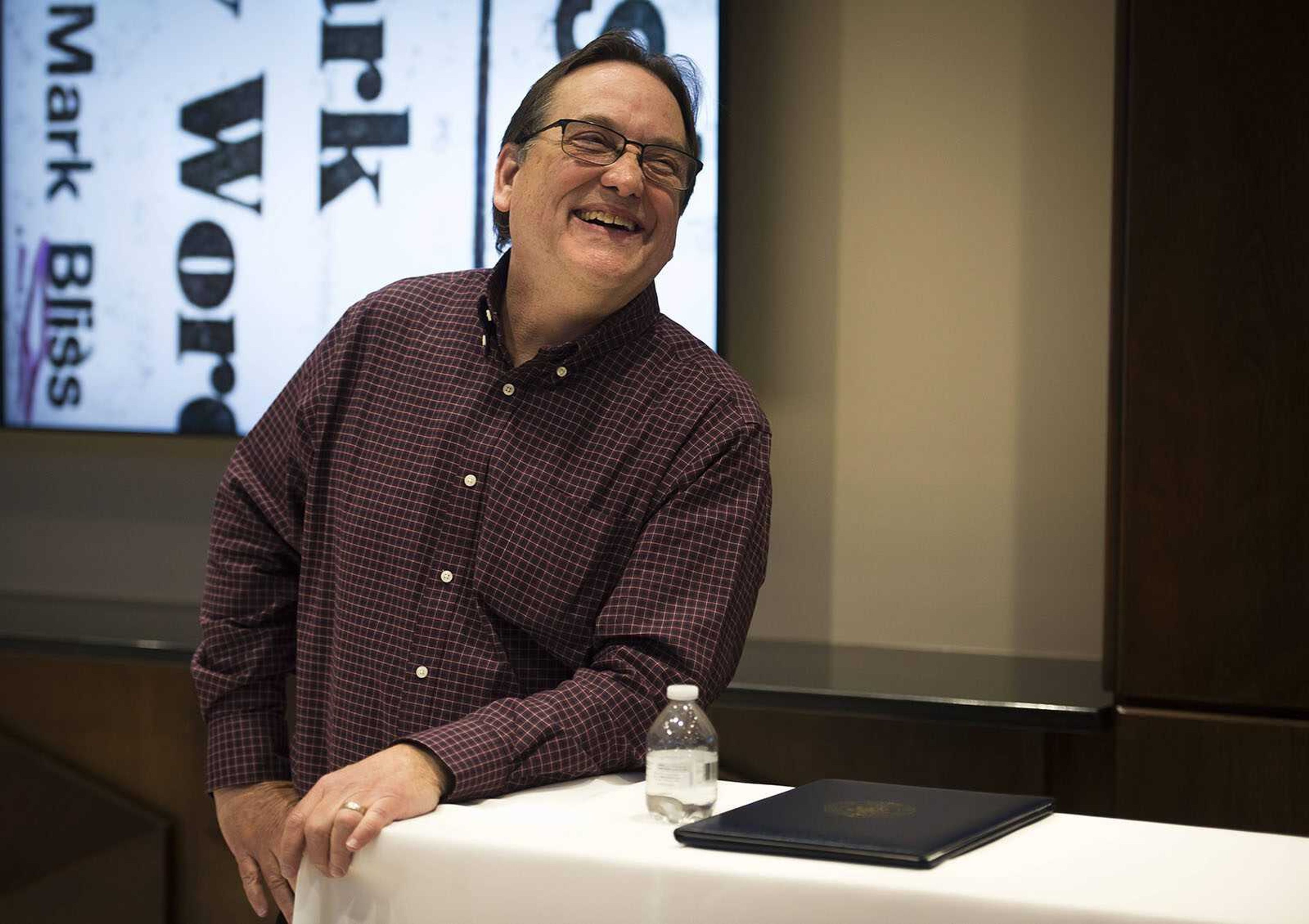 Southeast Missourian journalist Mark Bliss laughs as speeches are given at his retirement reception Monday, Nov. 25, 2019, inside the Bullpen at the Rust Center for Media in Cape Girardeau.