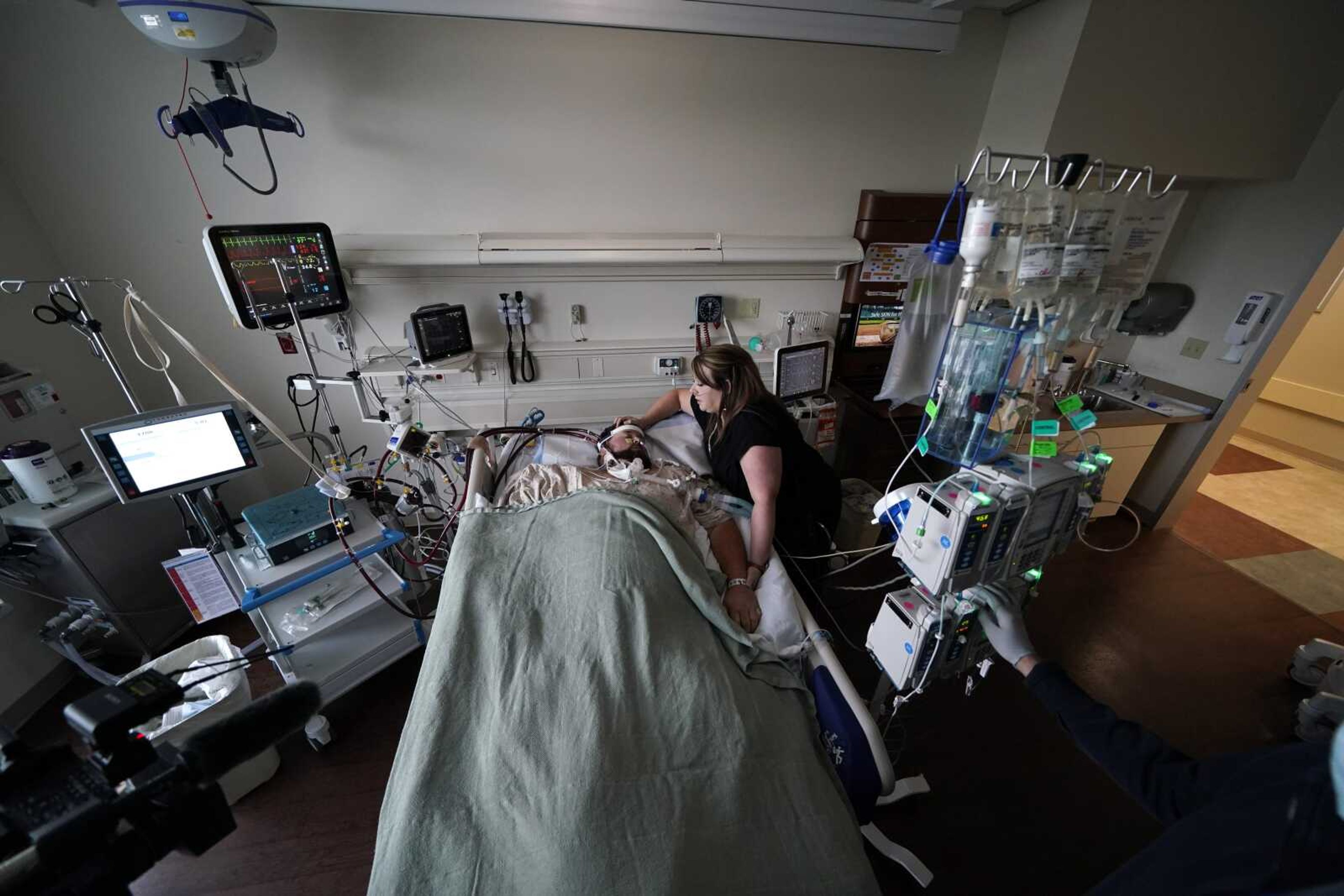 Lauren Debroeck, who is on oxygen as she recovers from COVID-19, talks to her husband, Michael, who also contracted COVID-19 and is being kept alive with the help of an oxygenation machine, at Willis-Knighton Medical Center on Aug. 18 in Shreveport, Louisiana.