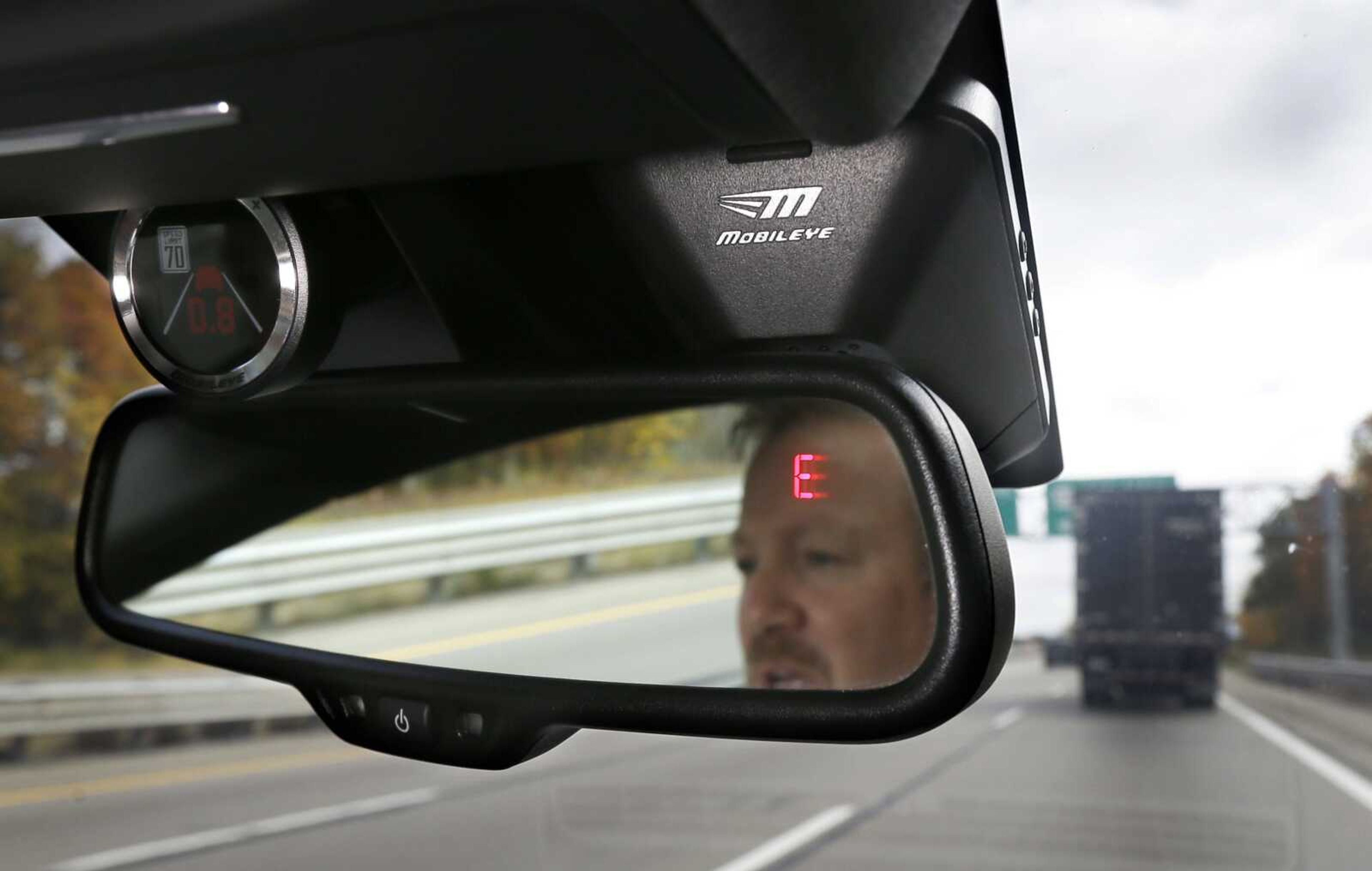 This photo shows a Mobileye camera system that can be installed behind the rearview mirror in your car to monitor speed limits and warn drivers of potential collisions. (AP Photo/Carlos Osorio)