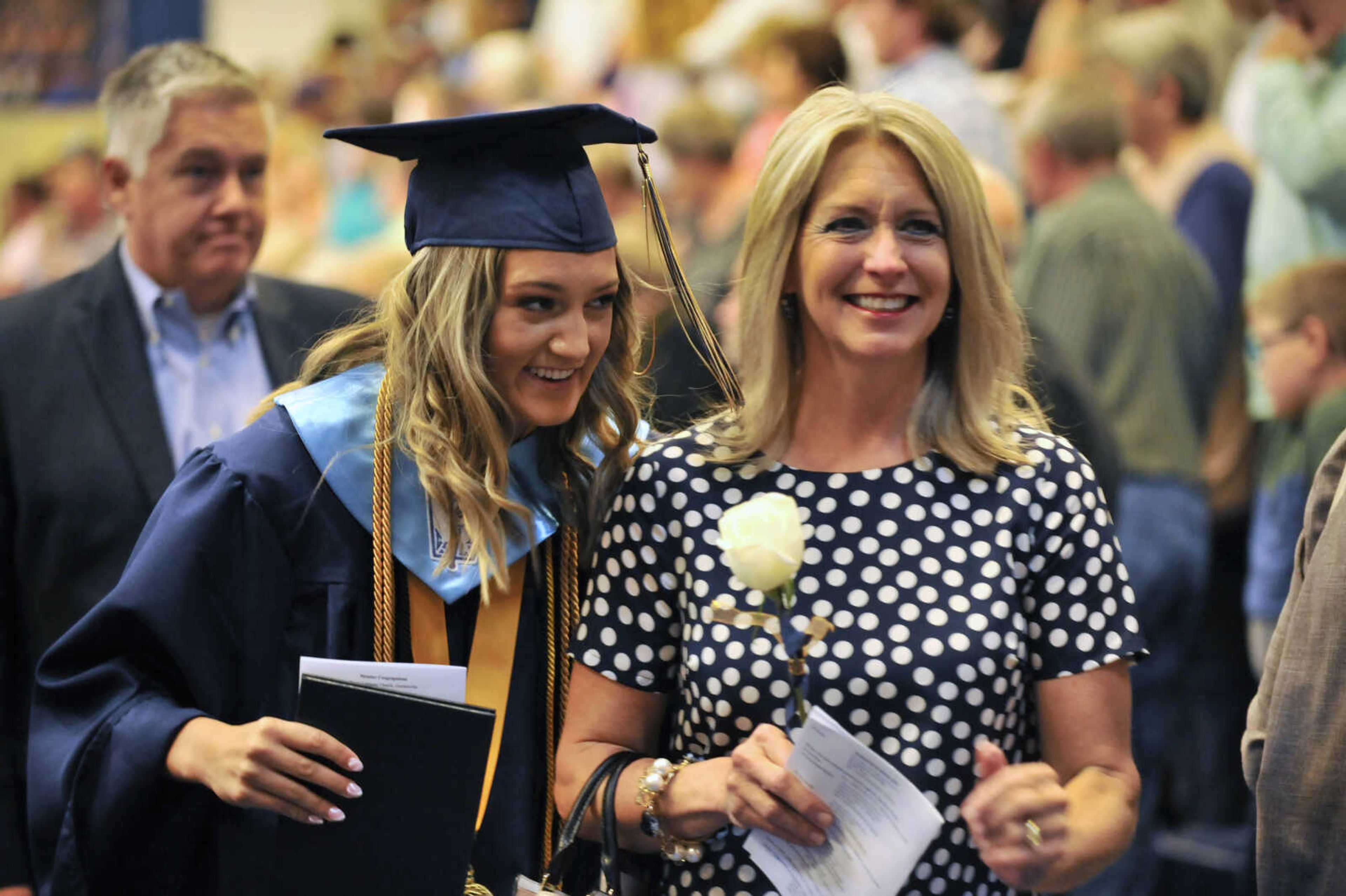 Graduate Maddox Murphy leaves Saxony Lutheran High School's gym with her mother after commencement at Saxony Lutheran High School on Sunday, May 16, 2021.