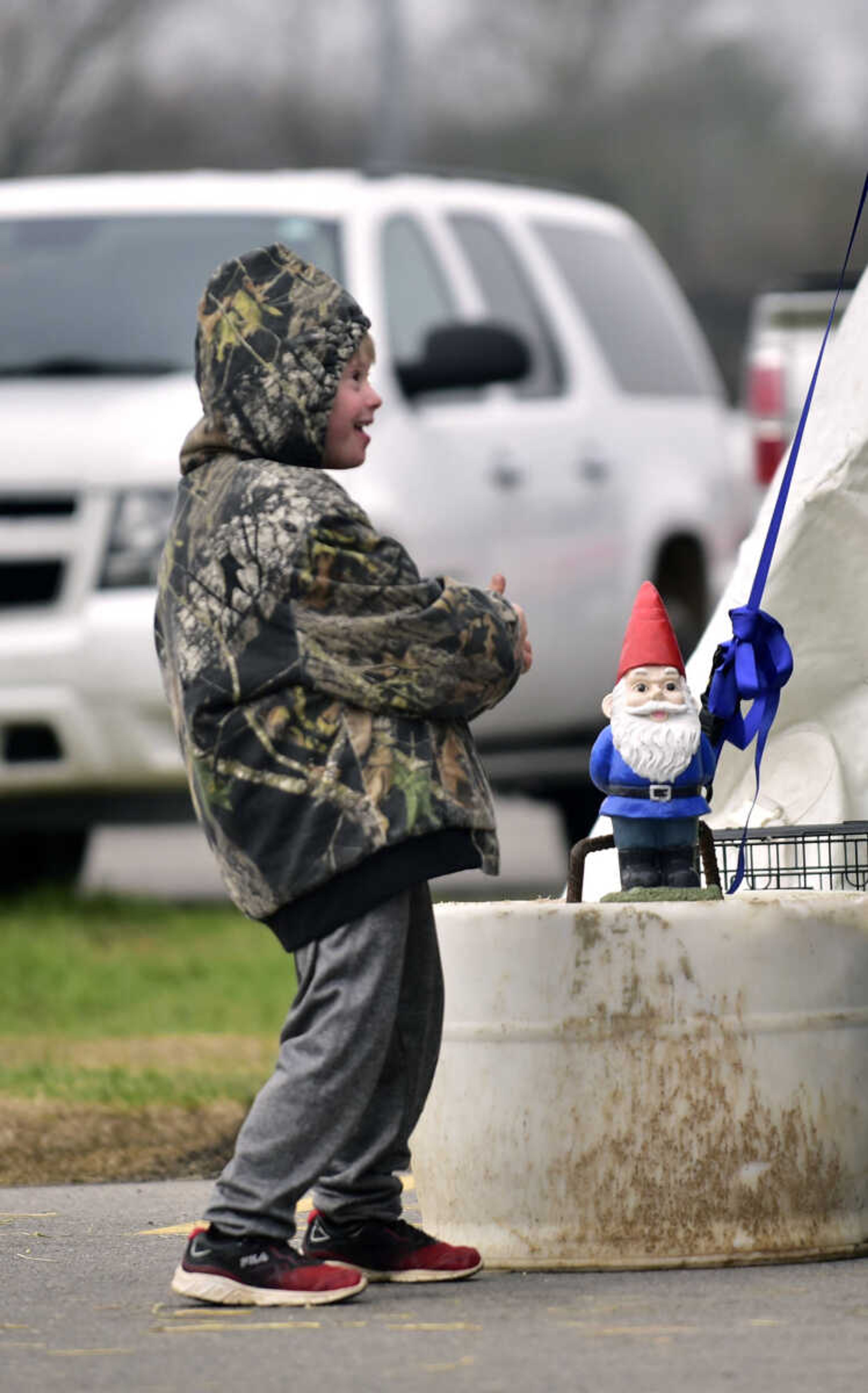 Caleb Wilkinson, 8, gives a thumbs-up to a garden gnome at the Cousin Carl Farm Show on Saturday, March 10, 2018, at Arena Park in Cape Girardeau.