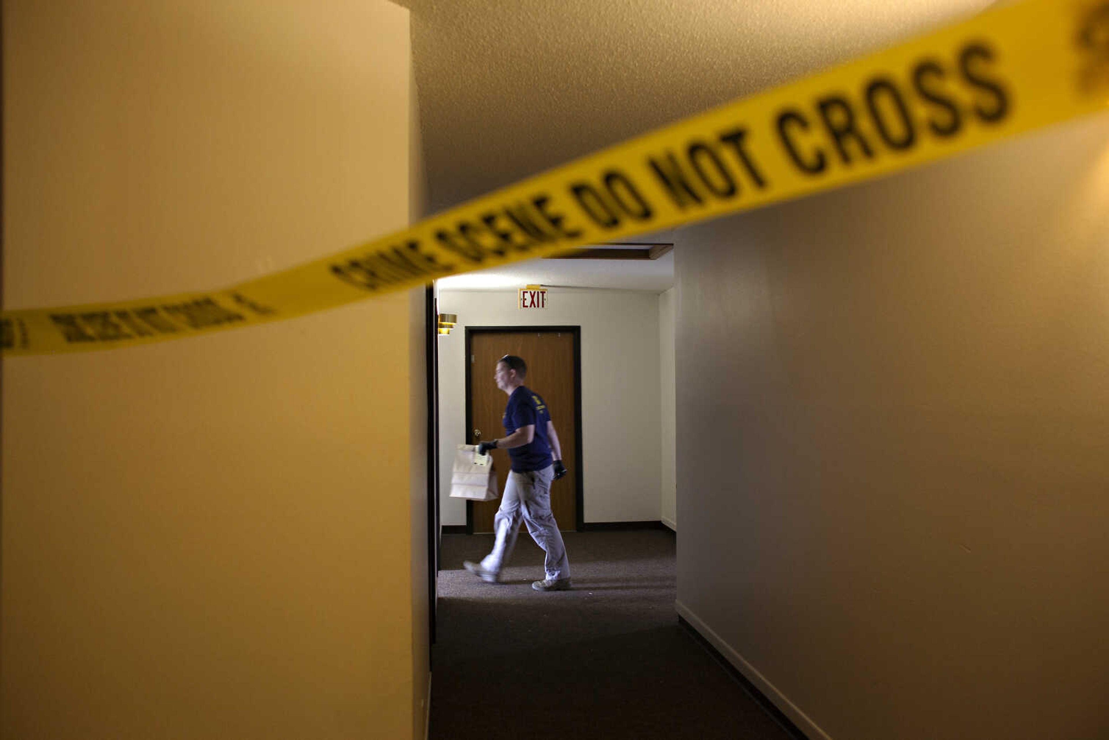 An FBI Evidence Response Team investigator walks behind crime scene July 15 in Fargo, North Dakota. Data in the FBI's annual crime report released Monday shows that violent crime across the U.S. decreased last year, dropping to about the same level as before the onset of the COVID-19 pandemic.