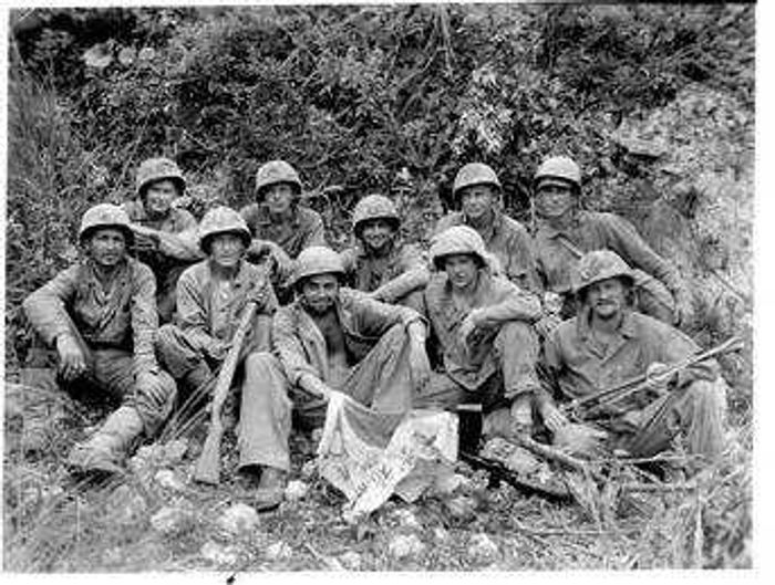 American Marines, including Pfc. Kenny Kasten from Southeast Missouri, top left, display a Japanese flag at the end of the Okinawa battle.