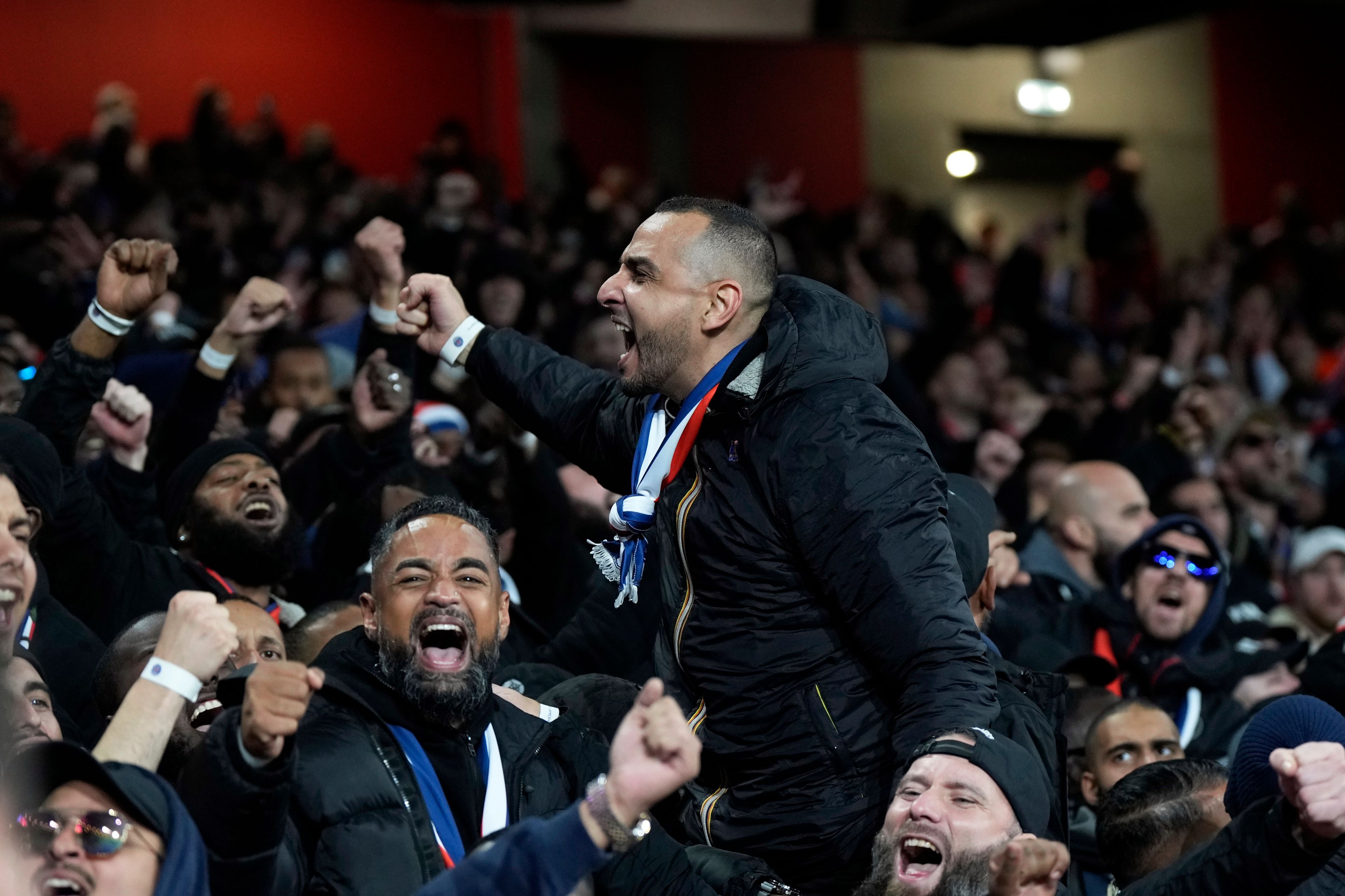 PSG fans cheer on the stands before the start of a Champions League opening phase soccer match between Arsenal FC and Paris Saint-Germain at Arsenal stadium in London, England, Tuesday, Oct. 1, 2024. (AP Photo/Alastair Grant)