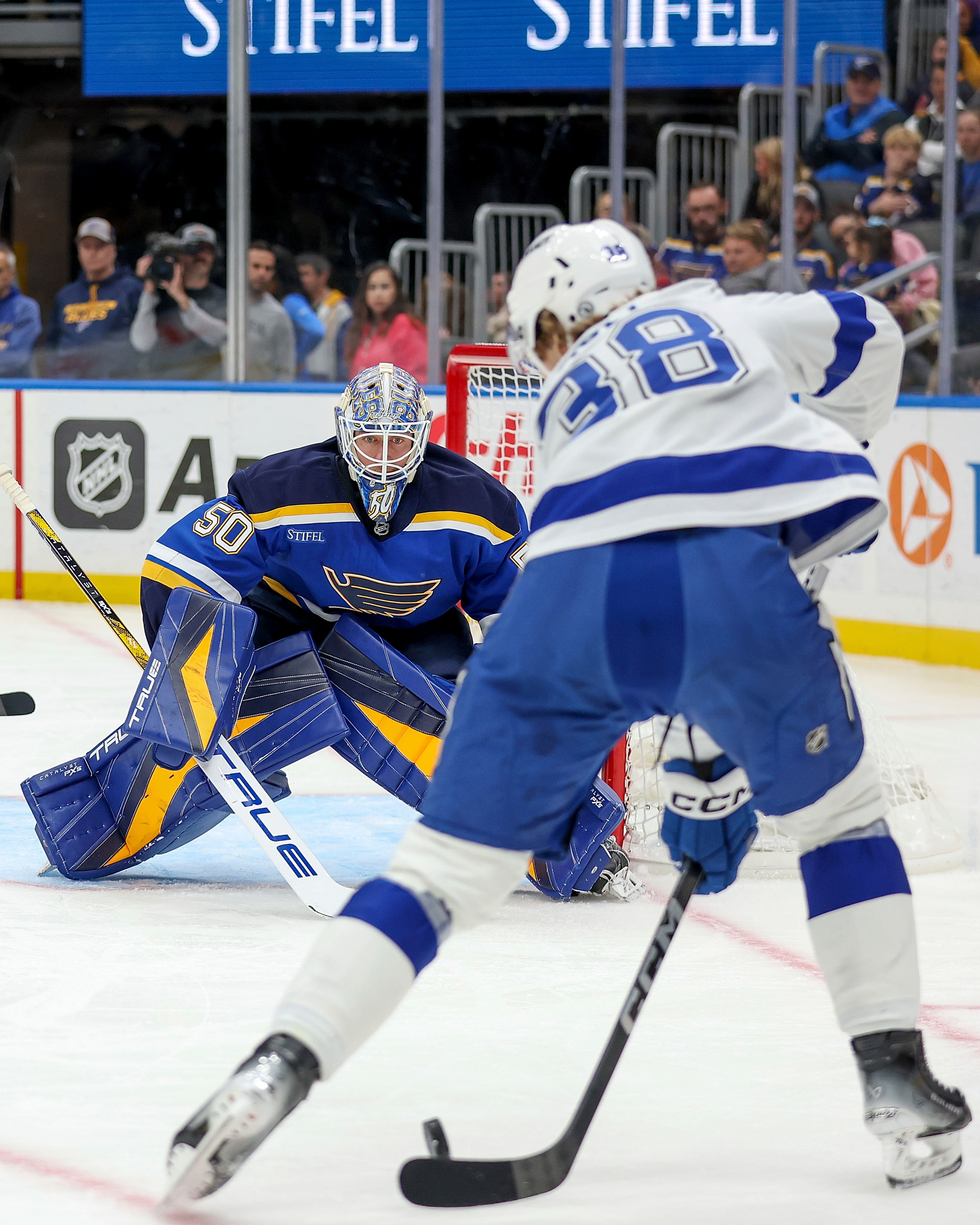 St. Louis Blues goaltender Jordan Binnington (50) defends against Tampa Bay Lightning's Brandon Hagel (38) during the first period of an NHL hockey game Tuesday, Nov. 5, 2024, in St. Louis. (AP Photo/Scott Kane)