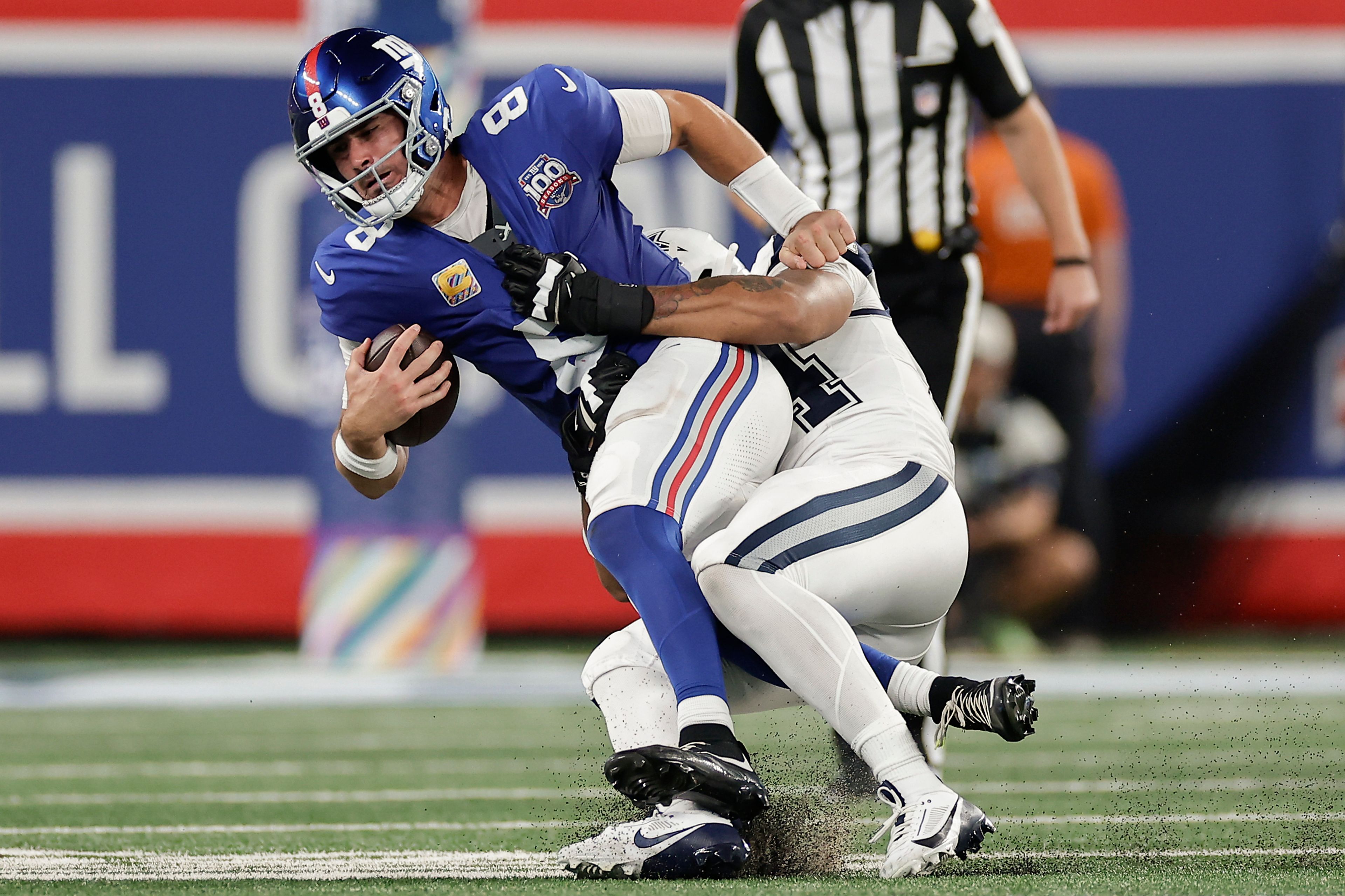 New York Giants quarterback Daniel Jones (8) is sacked by Dallas Cowboys defensive end Marshawn Kneeland (94) during the third quarter of an NFL football game, Thursday, Sept. 26, 2024, in East Rutherford, N.J. (AP Photo/Adam Hunger)