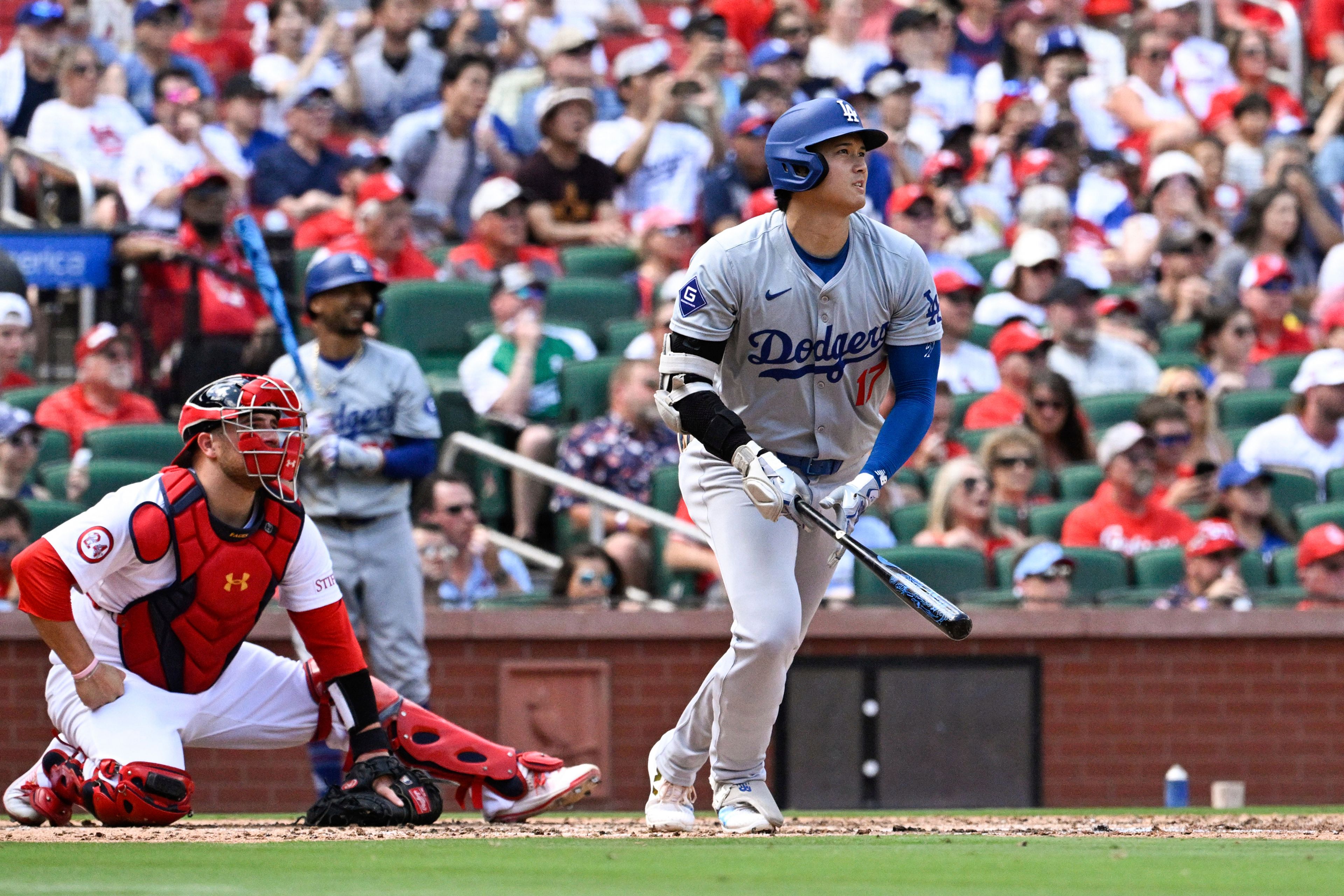 Los Angeles Dodgers designated hitter Shohei Ohtani, right, watches his home run against the St. Louis Cardinals during the fifth inning of a baseball game Sunday, Aug. 18, 2024, in St. Louis. (AP Photo/Jeff Le)