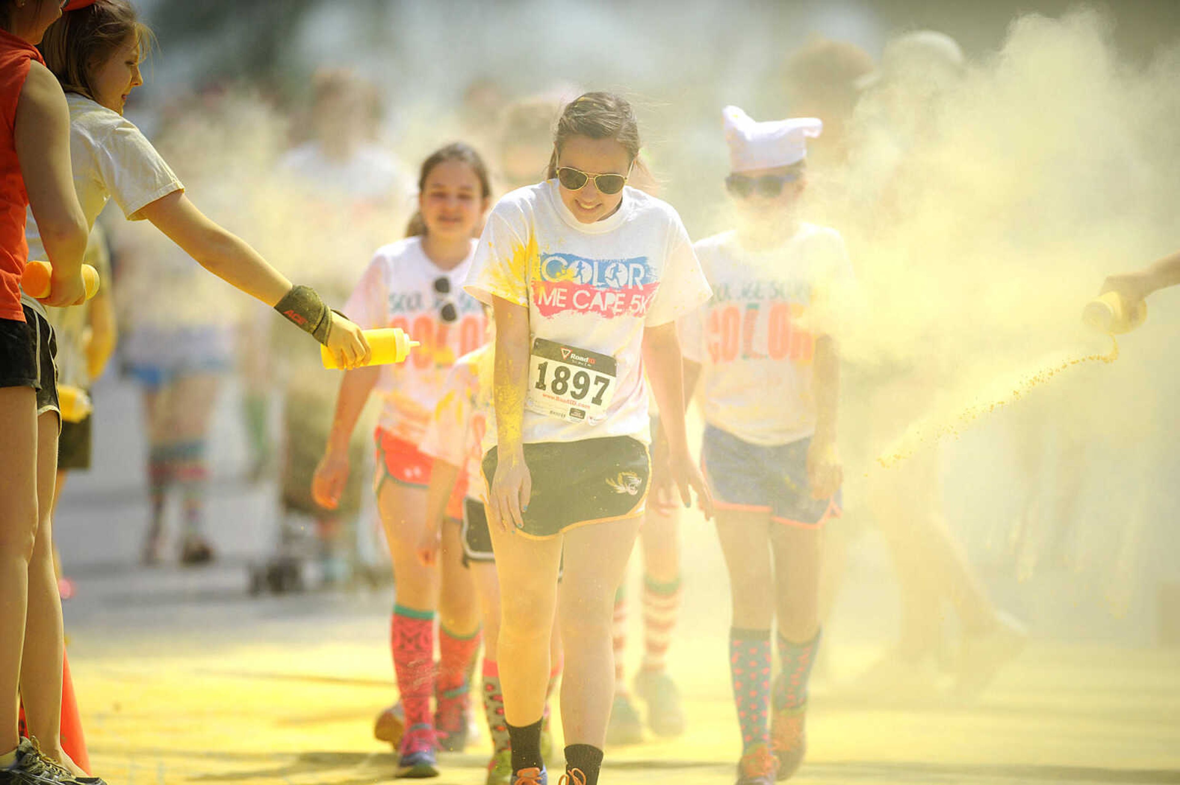 LAURA SIMON ~ lsimon@semissourian.com

Participants in the Color Me Cape 5K are sprayed with yellow powder at the second color station on Frederick Street, Saturday, April 12, 2014, in Cape Girardeau.