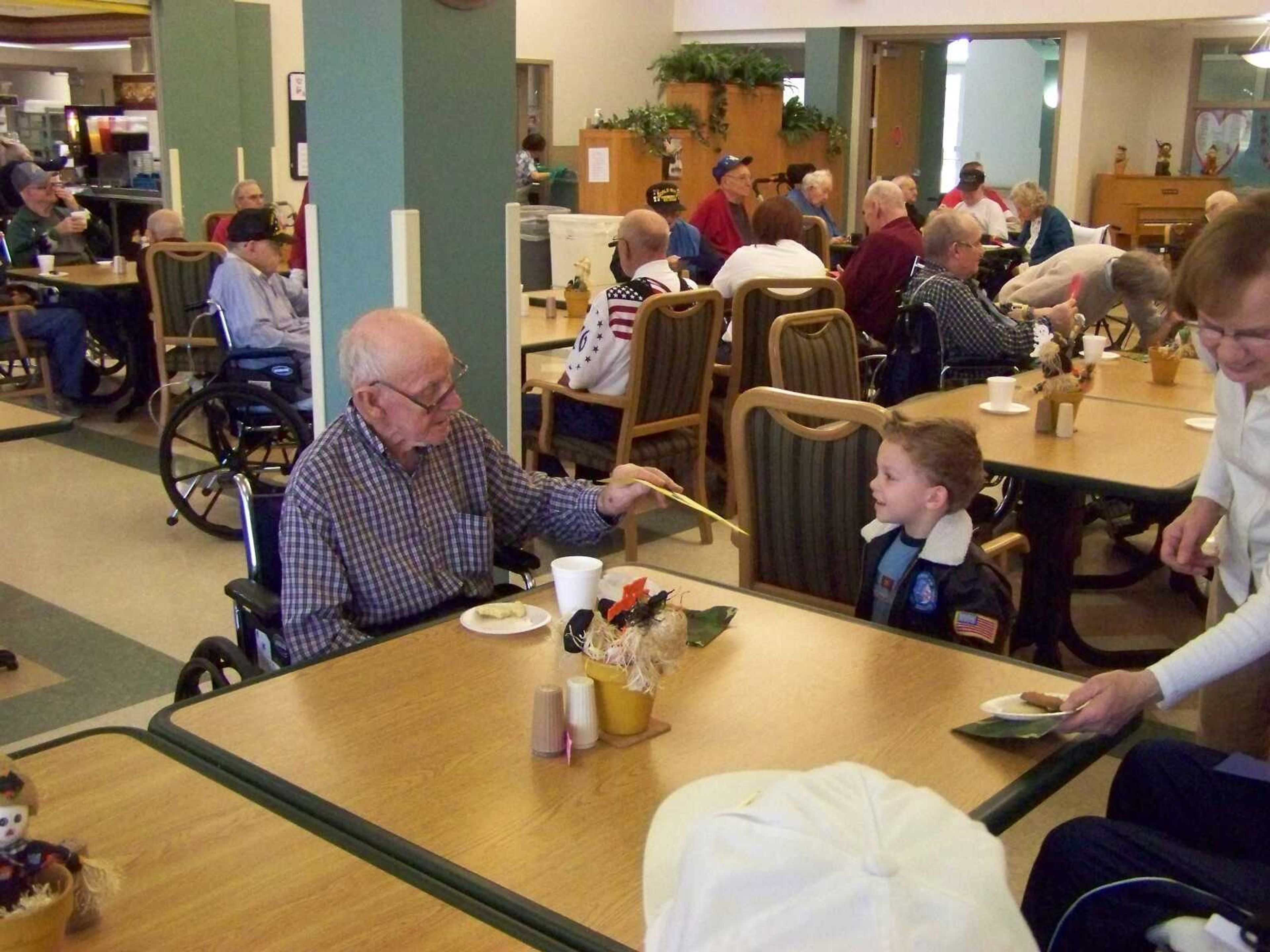 Fred Nebel, a veteran and resident of the Veteran's Home receives a card of thanks from one of the children of A Small World's Kid's Club.