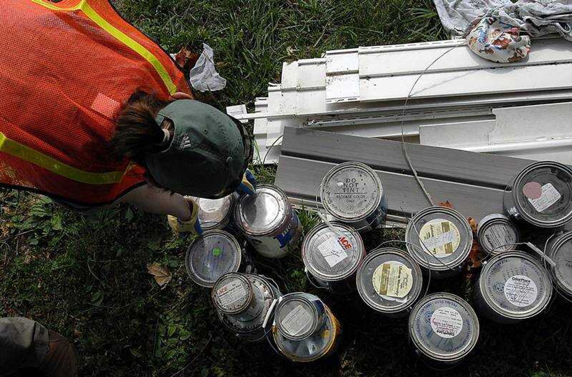 KIT DOYLE ~ kdoyle@semissourian.com
Callie Miller bent to pick up paint cans Thursday morning, June 26, 2008, while getting Knee Deep with the Jackson Sanitation Department. Trash collecting was especially difficult because of of Jackson annual Spring Cleaning Pickup when residents may put out as much as possible. They collected things ranging from paint to baby diapers to sofas to rotten food.