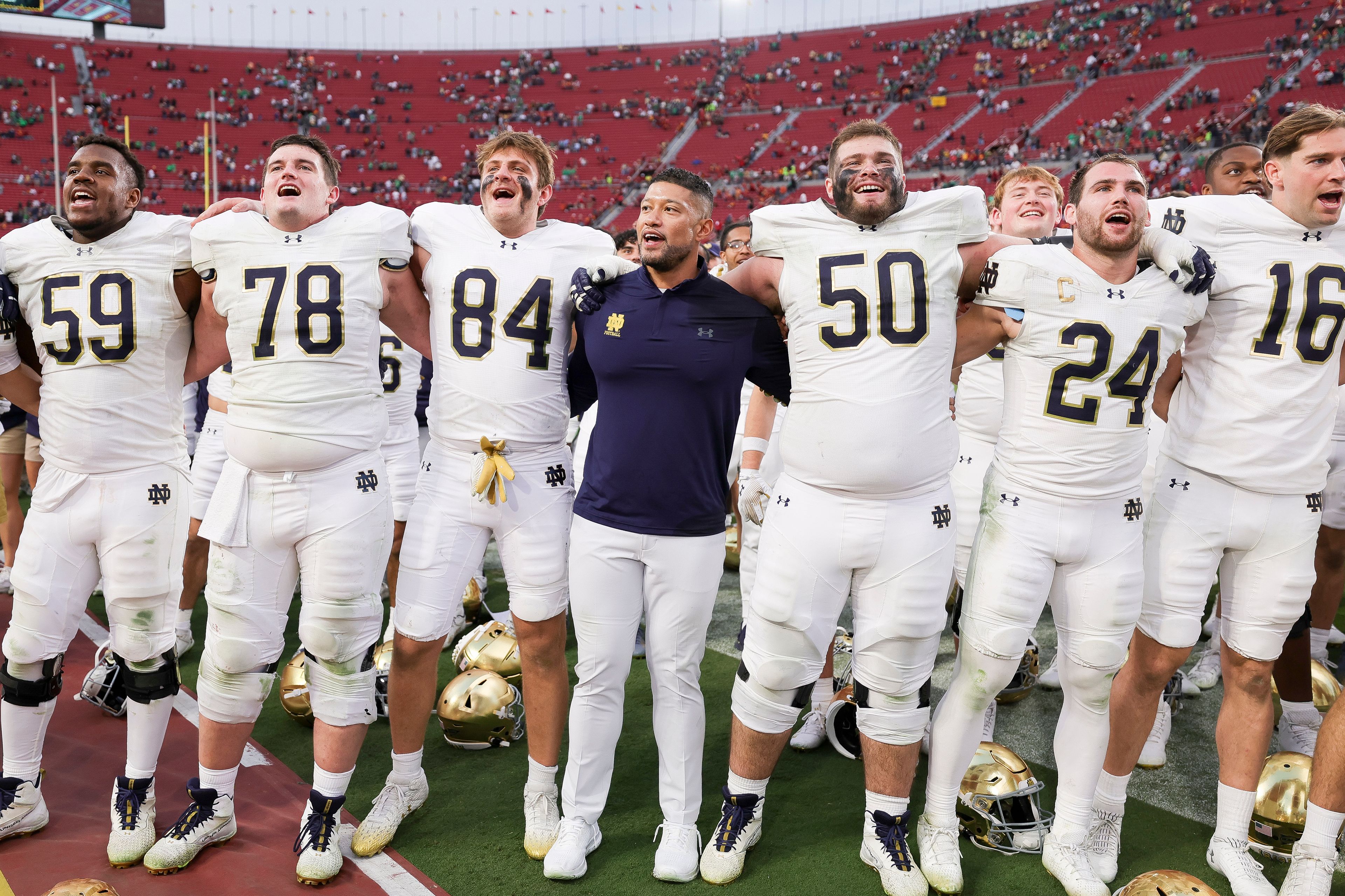 Notre Dame head coach Marcus Freeman, center, chants with his players after the team's win against Southern California in an NCAA college football game Saturday, Nov. 30, 2024, in Los Angeles. (AP Photo/Ryan Sun)