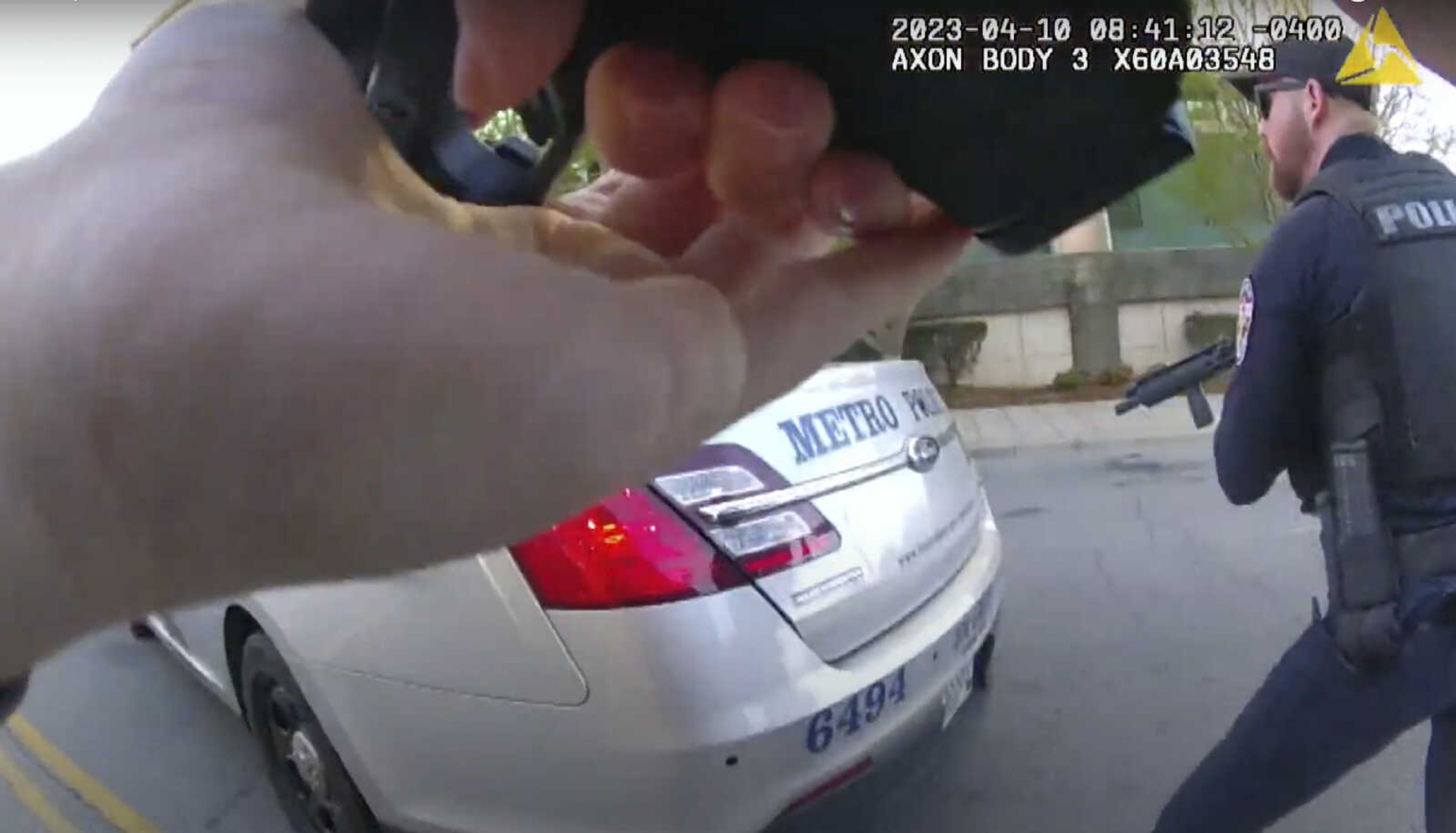 This screen grab taken from the body-camera video of Louisville Metro Police Department officer Nickolas Wilt, left foreground, shows officer Cory Galloway, right, with his weapon drawn as the two officers approach an active shooting situation Monday at Old National Bank in Louisville, Kentucky.