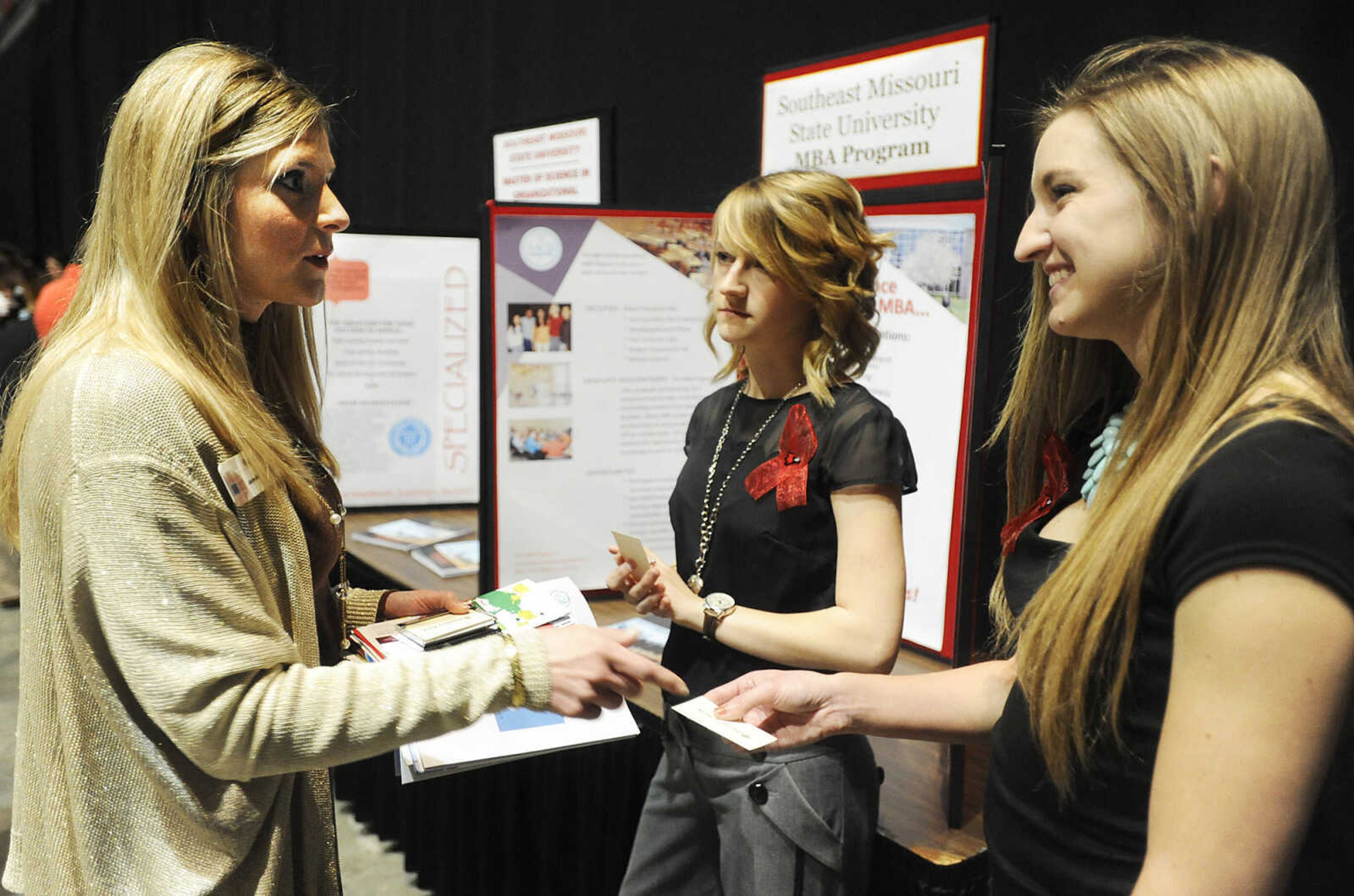 Southeast Missouri State University MBA students Amber Brewer, right, and Sonya Allen talk with Jeanne Churchill of Bantera Bank, left, at the Power of Women luncheon March 13, 2013, at the Show Me Center in Cape Girardeau. The event seeks to connect female students at Southeast with opportunities, women mentors and resources in the community.