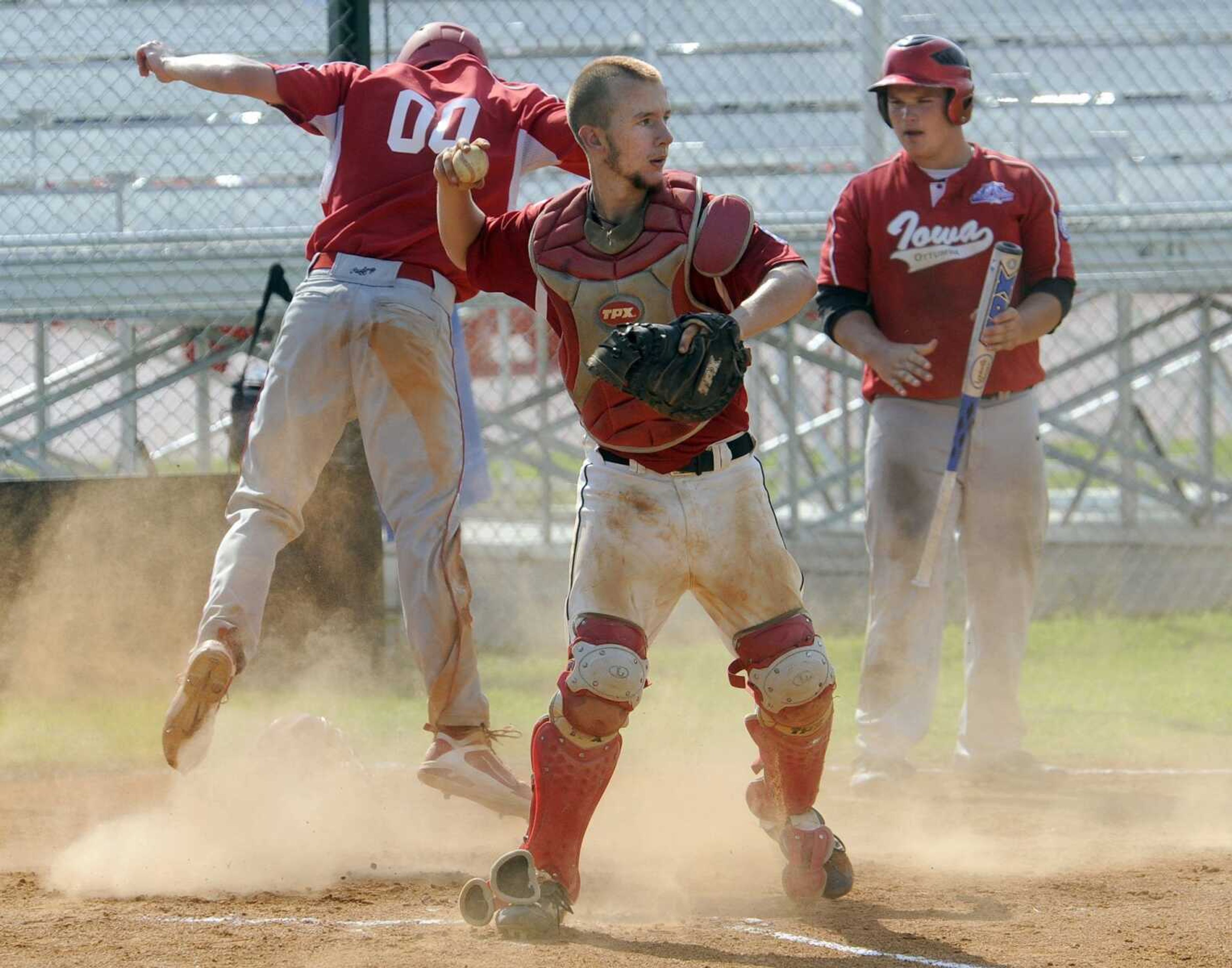 Chaffee catcher Cody Payne is unable to tag Iowa baserunner Tyler Evans during the second inning Saturday at the Midwest Plains Regional tournament in Charleston, Mo. (Fred Lynch)