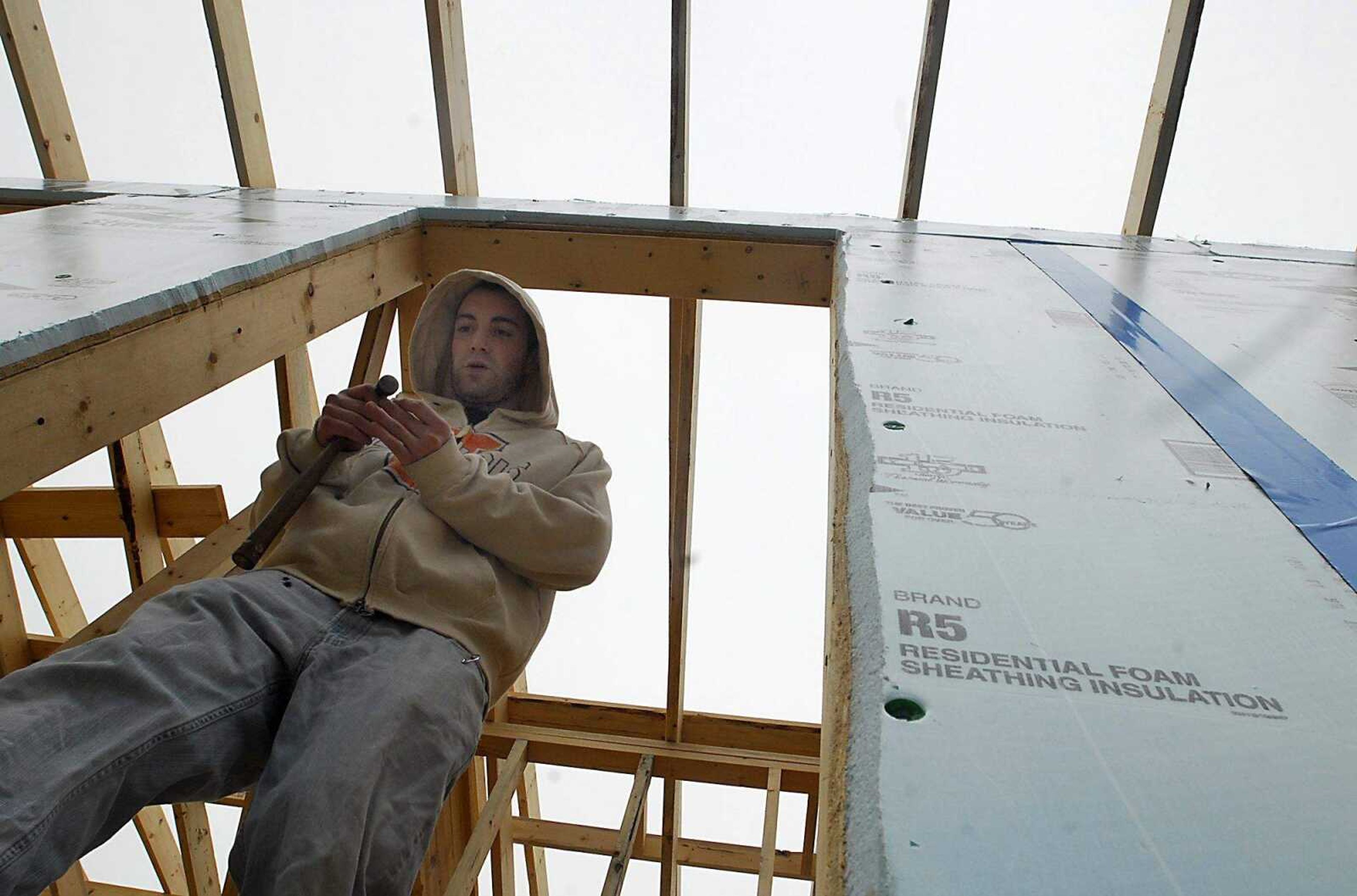 KIT DOYLE ~ kdoyle@semissourian.com
Jarod Goetter exits the Habitat for Humanity home he is volunteering to build Thursday, March 12, 2009, in Cape Girardeau.