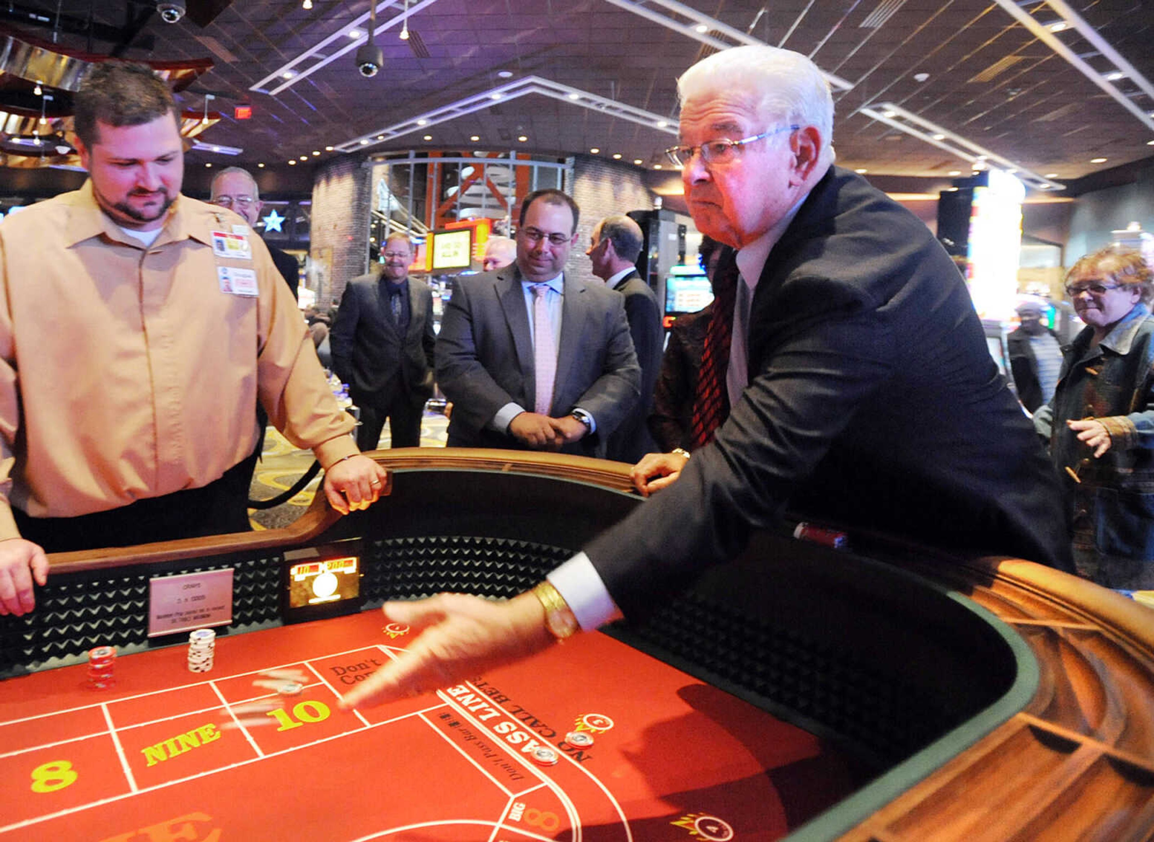 Cape Girardeau Mayor Harry Rediger throws the first dice at the craps table Tuesday, Oct. 30, 2012 at Isle of Capri in Cape Girardeau. The $135 million casino opened to the public Tuesday morning. (Laura Simon)