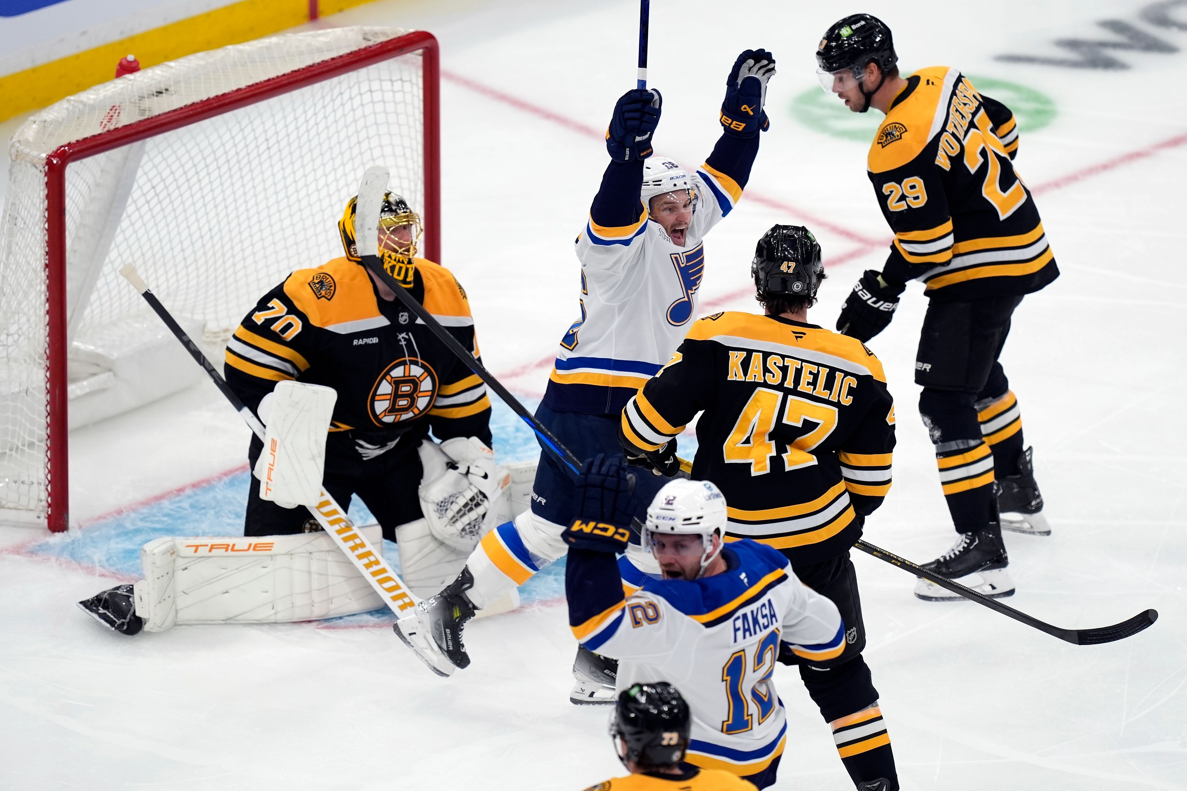 St. Louis Blues' Nathan Walker (26) celebrates a goal by Radek Faksa (12) past Boston Bruins' Joonas Korpisalo (70) during the first period of an NHL hockey game, Saturday, Nov. 16, 2024, in Boston. (AP Photo/Michael Dwyer)