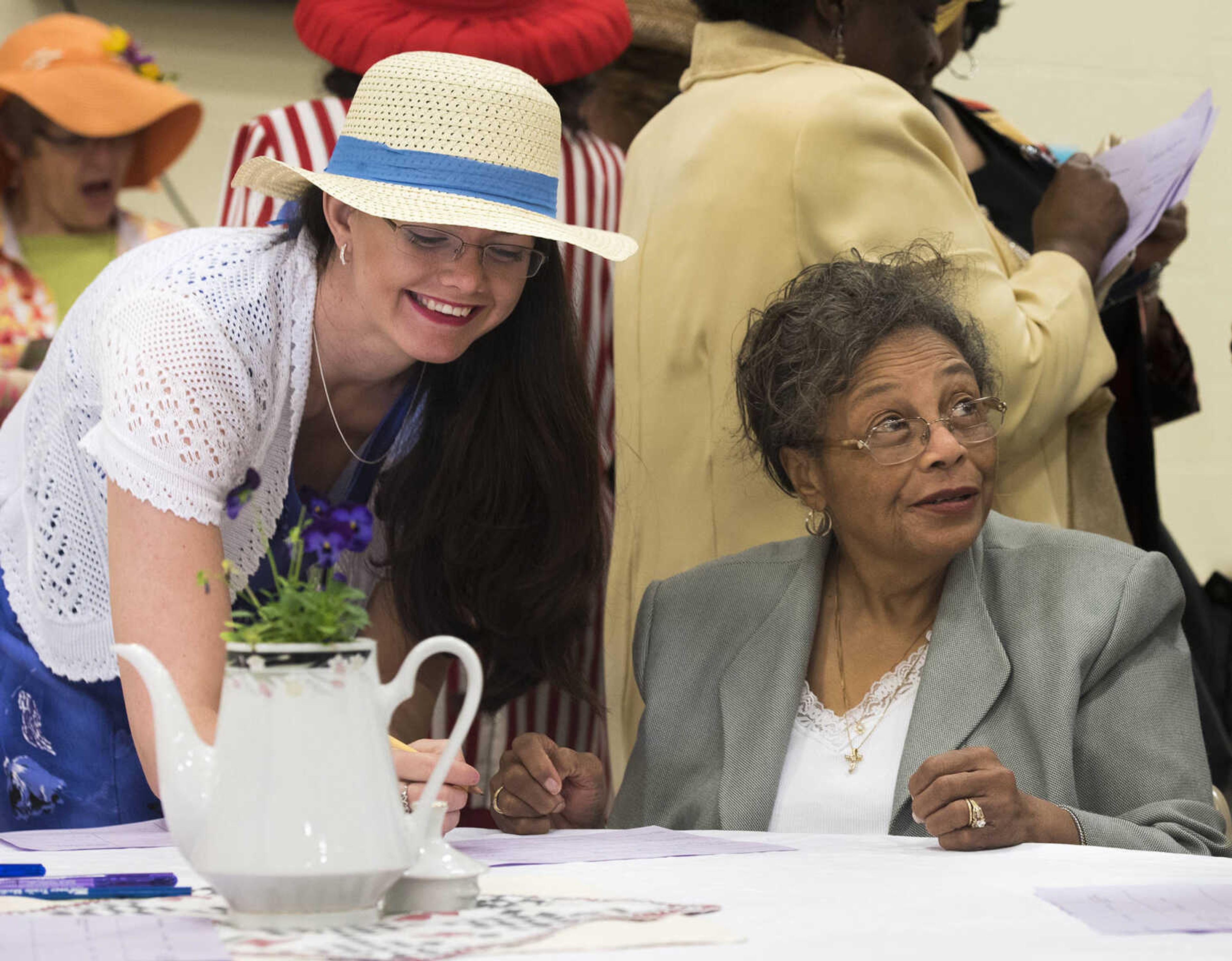 Vallarie Santhuff and Bernice Campbell socialize during an icebreaker at a ladies' tea and sweets event hosted by Stop Needless Acts of Violence Please on April 1, 2017 at the Shawnee Park Center in Cape Girardeau.