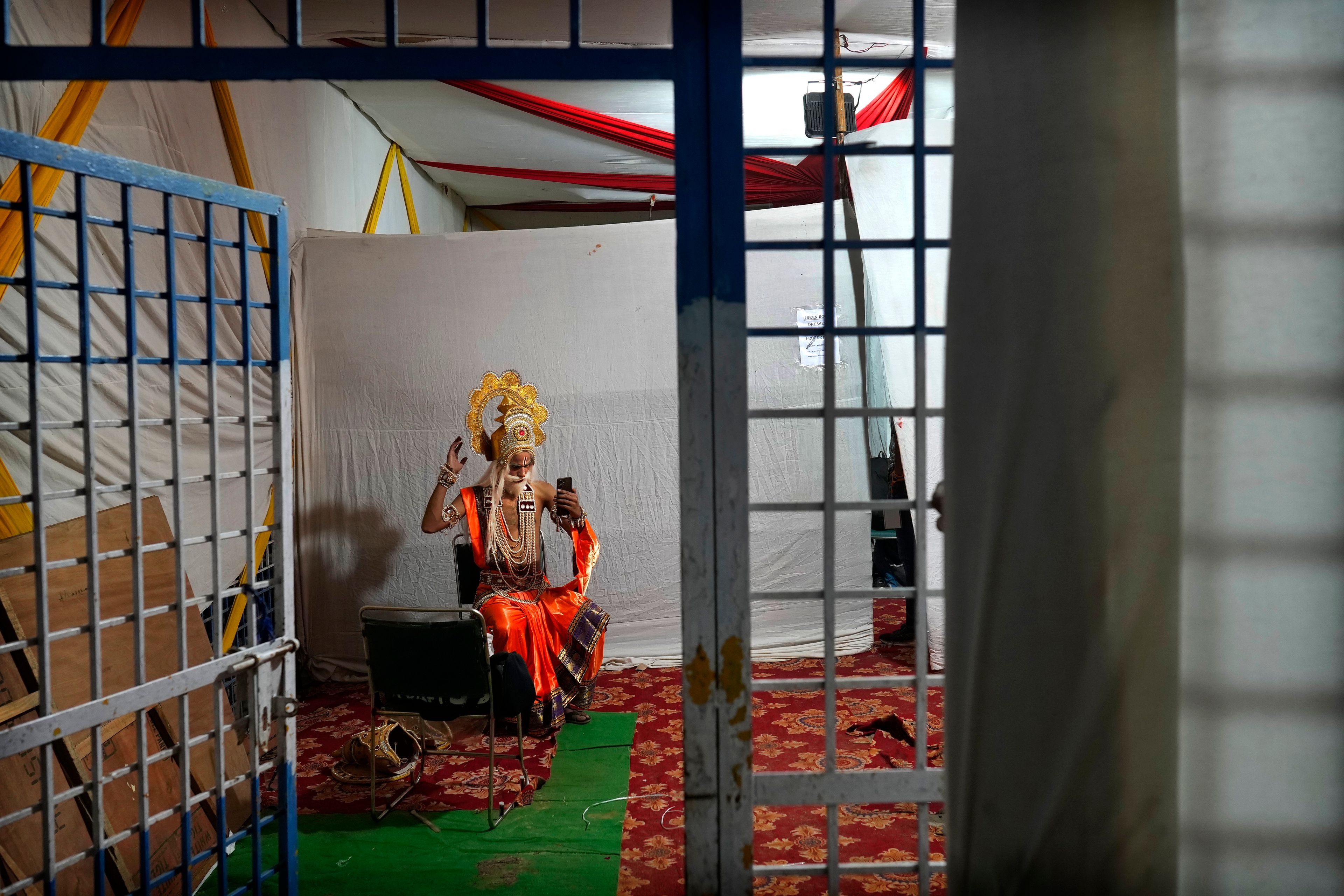 An actor rehearses his lines backstage before the start of Ramleela, a dramatic folk re-enactment of the life of Hindu god Rama according to the ancient Hindu epic Ramayana, in New Delhi, India, Saturday, Oct. 5, 2024. (AP Photo/Manish Swarup)