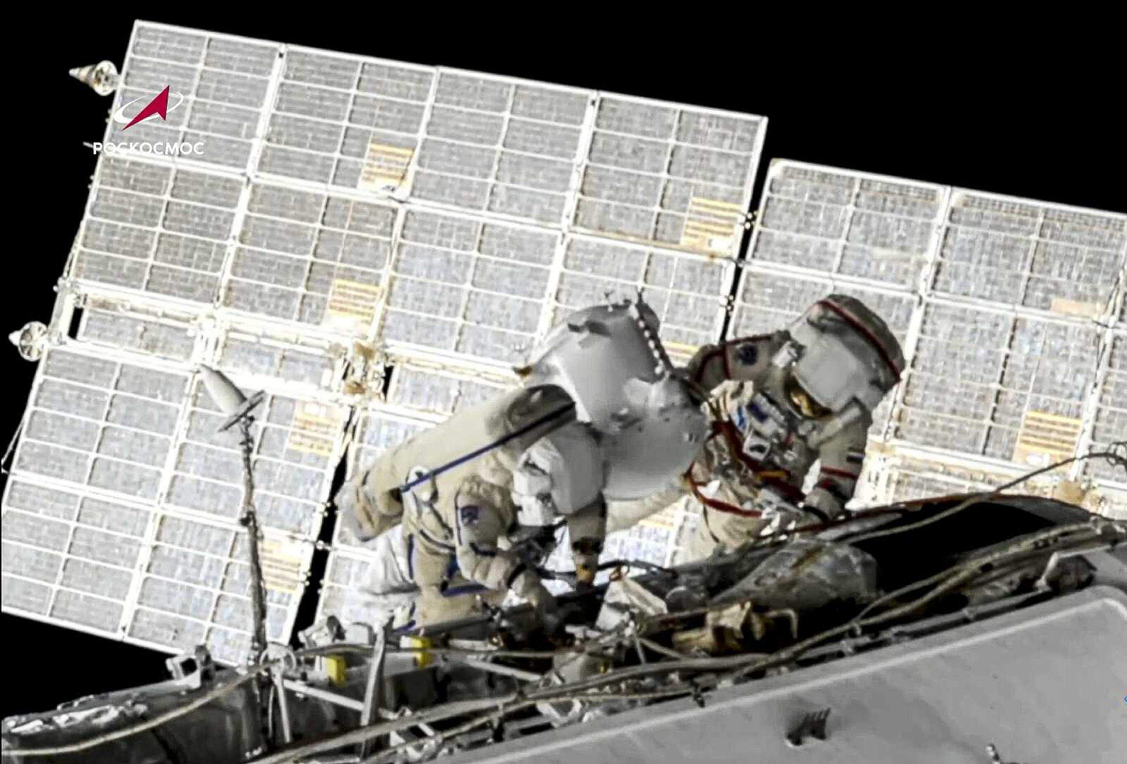 Russian cosmonauts Oleg Novitsky, right, and Pyotr Dubrov, members of the crew to the International Space Station, perform their first spacewalk June 2, 2021, to replace old batteries outside the International Space Station.