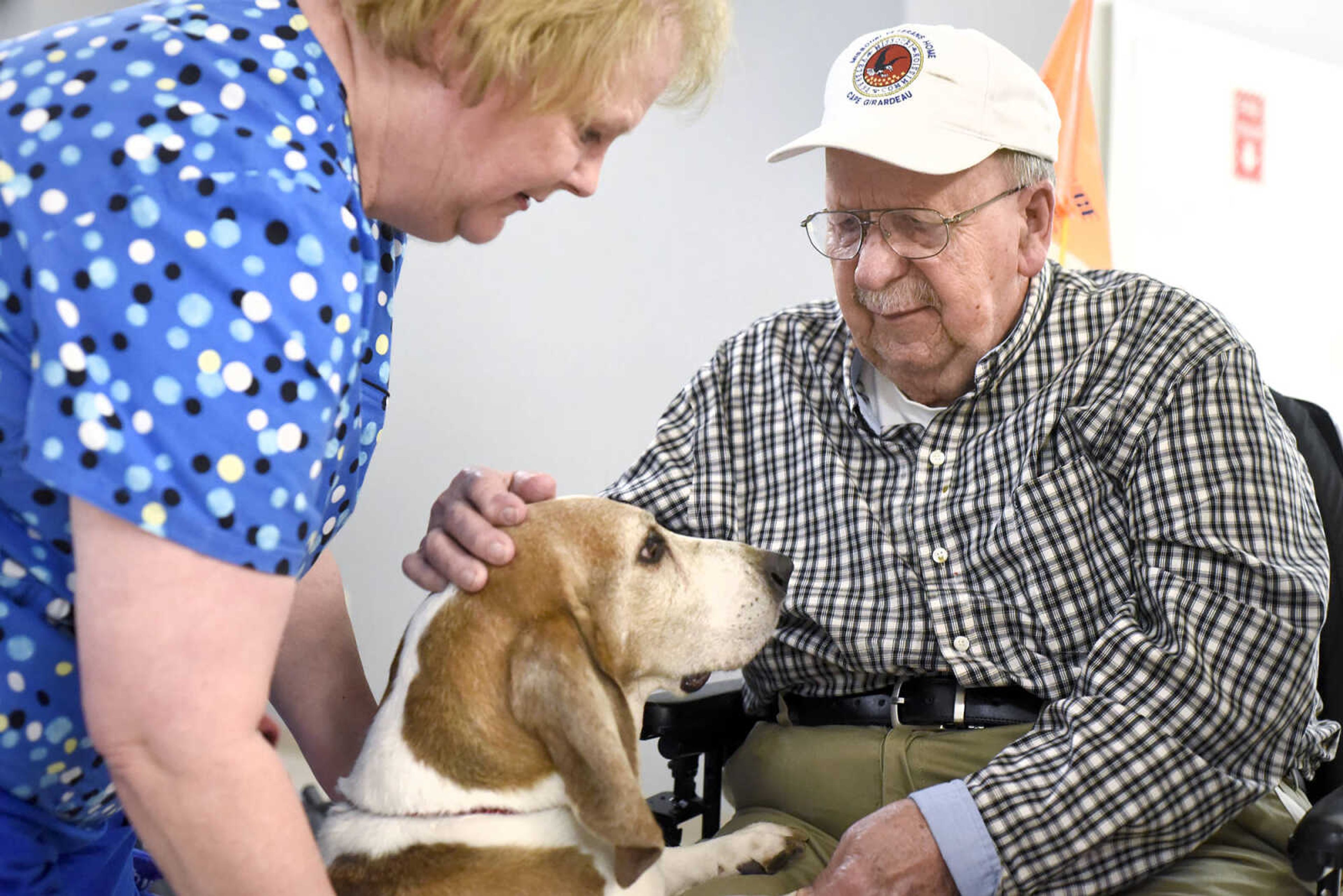 Laura Hurst introduces her dog, Abner, to Carl Henneke on Tuesday, Feb. 21, 2017, during the Pet Pals visit at the Missouri Veteran's Home in Cape Girardeau.