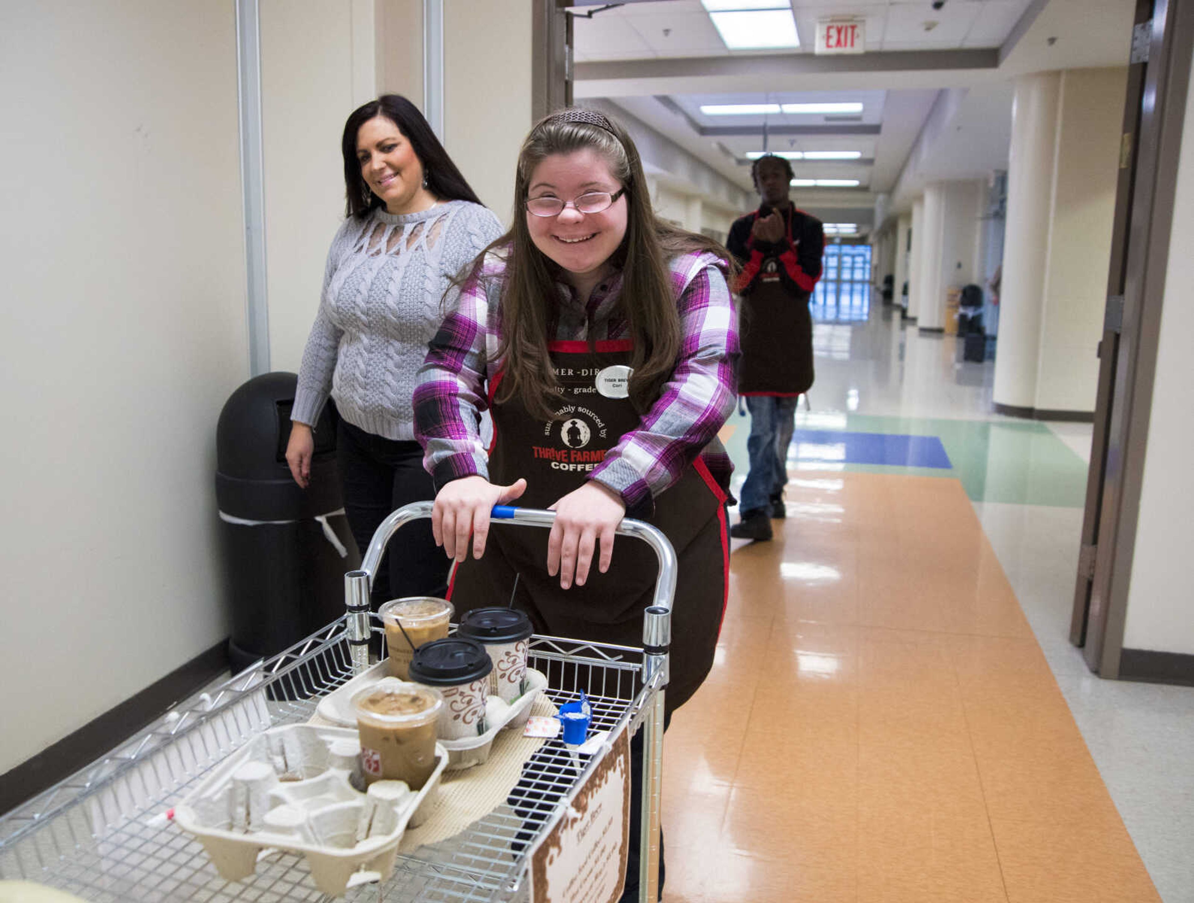 ANDREW J. WHITAKER ~ awhitaker@semissourian.com
Cori Brennecke pushes the Tiger Brew drink cart down the hall with Stacy Klusmeier and Tevontay Hulbert for Tiger Brew, a student run business run by the special education department at Cape Girardeau Central, Tuesday, Dec. 13, 2016 in Cape Girardeau. Tiger Brew is available Monday through Friday during three different class periods, 1st hour, 2nd hour and advisory and offer a variety of drinks from hot coffees and teas, iced drinks, hot chocolates and even smoothies.