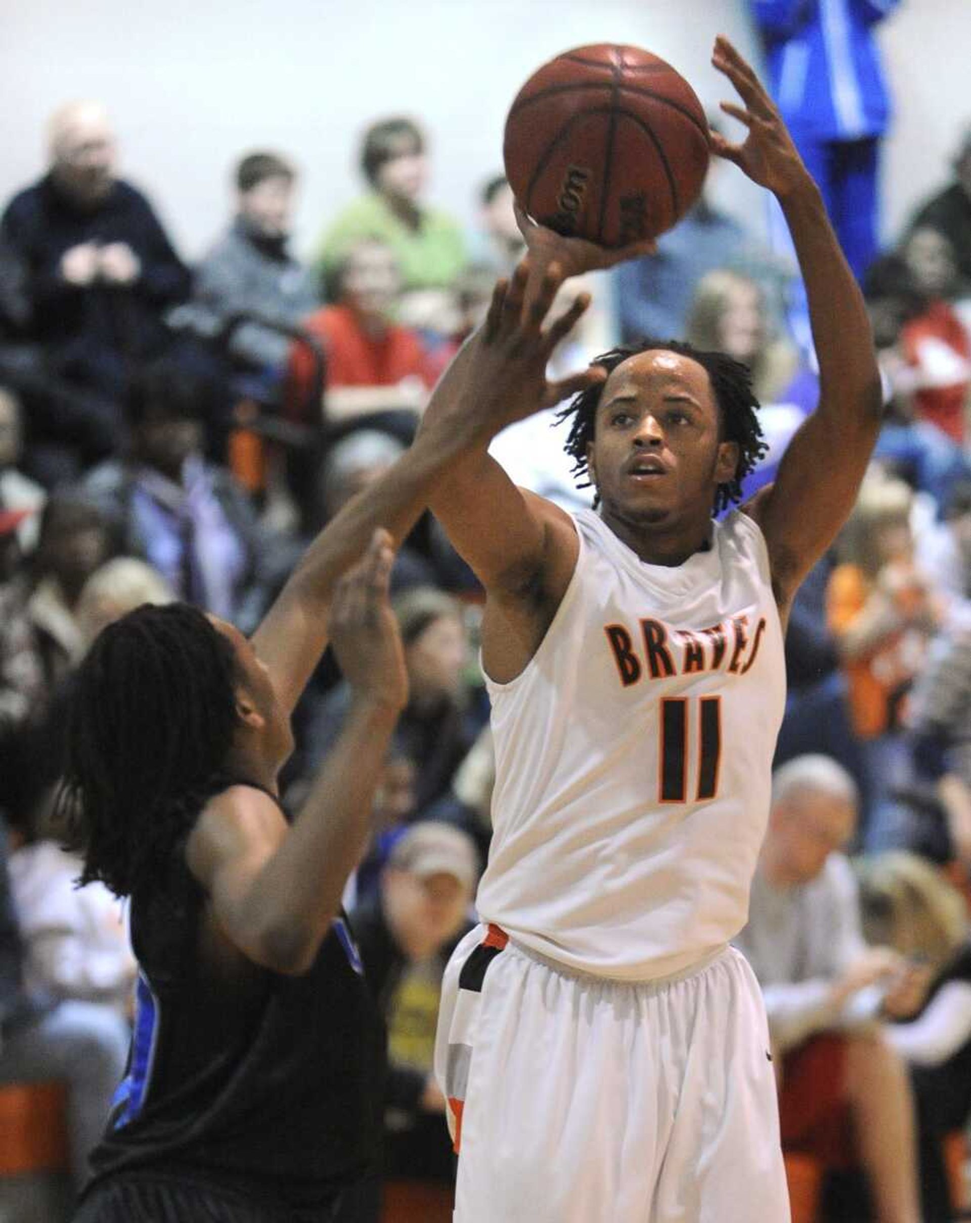 Scott County Central's Stewart Johnson shoots against Maplewood Richmond Heights' Corey Frazier during the fourth quarter Saturday, Feb. 19, 2011 at Scott County Central. (Fred Lynch)