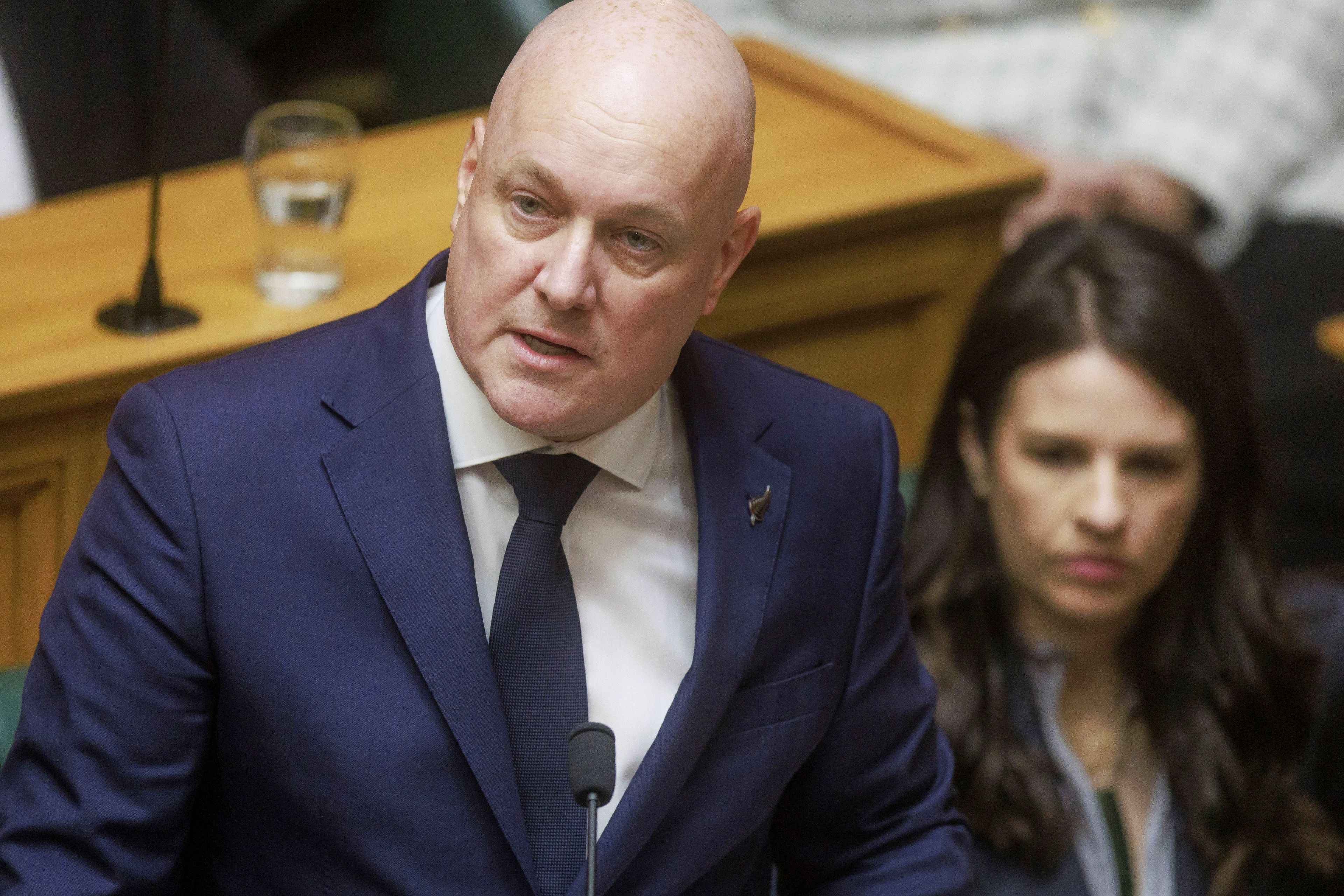 New Zealand's Prime Minister Christopher Luxon makes a "formal and unreserved" apology in Parliament for the widespread abuse, torture and neglect of hundreds of thousands of children and vulnerable adults in care, in Wellington, New Zealand, Tuesday, Nov. 12, 2024. (Robert Kitchin/Stuff via AP)