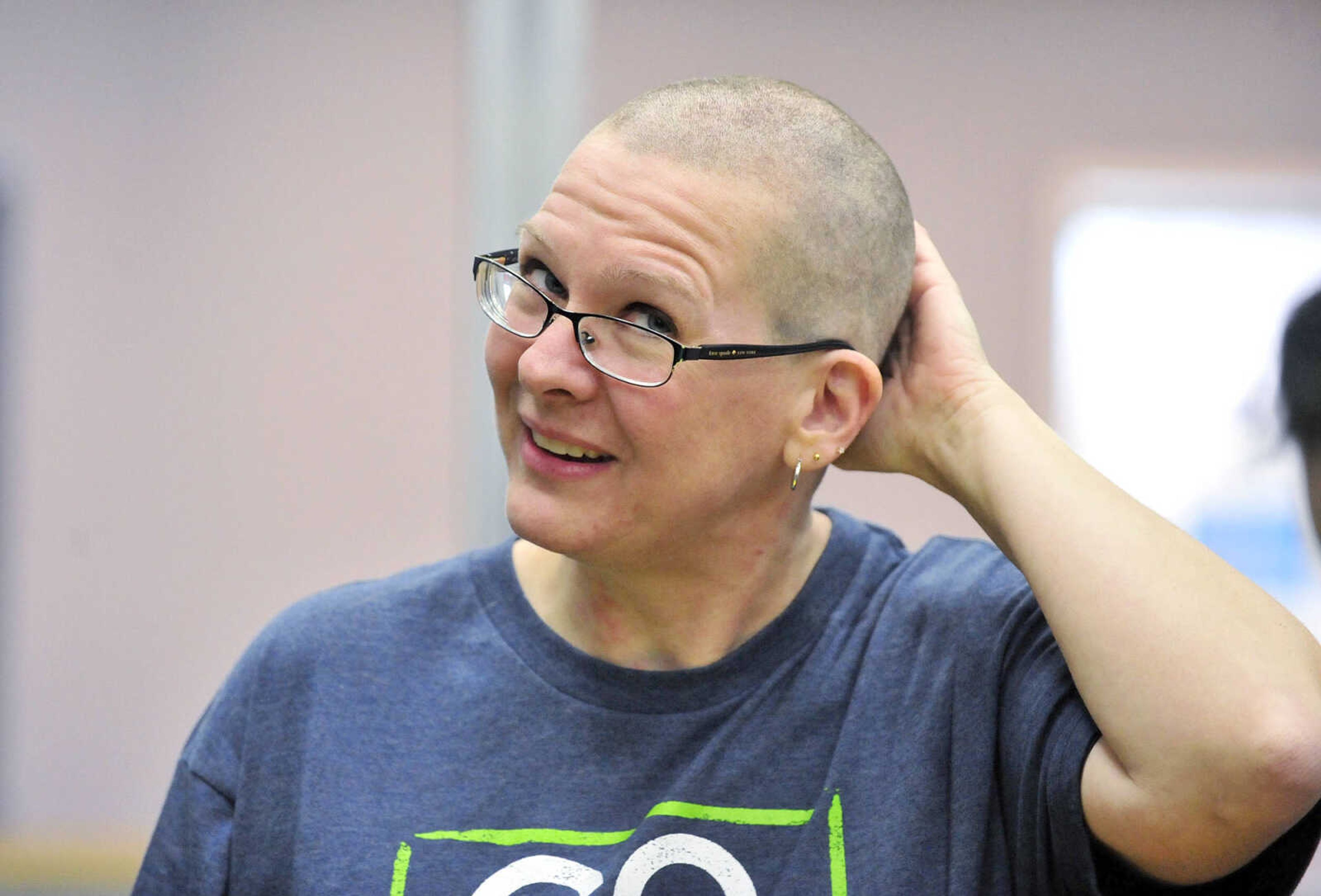 Jennifer Singleton feels her freshly shaven head on Saturday, March 4, 2017, during the St. Baldrick's Foundation fundraiser at Old Orchard CrossFit in Jackson.