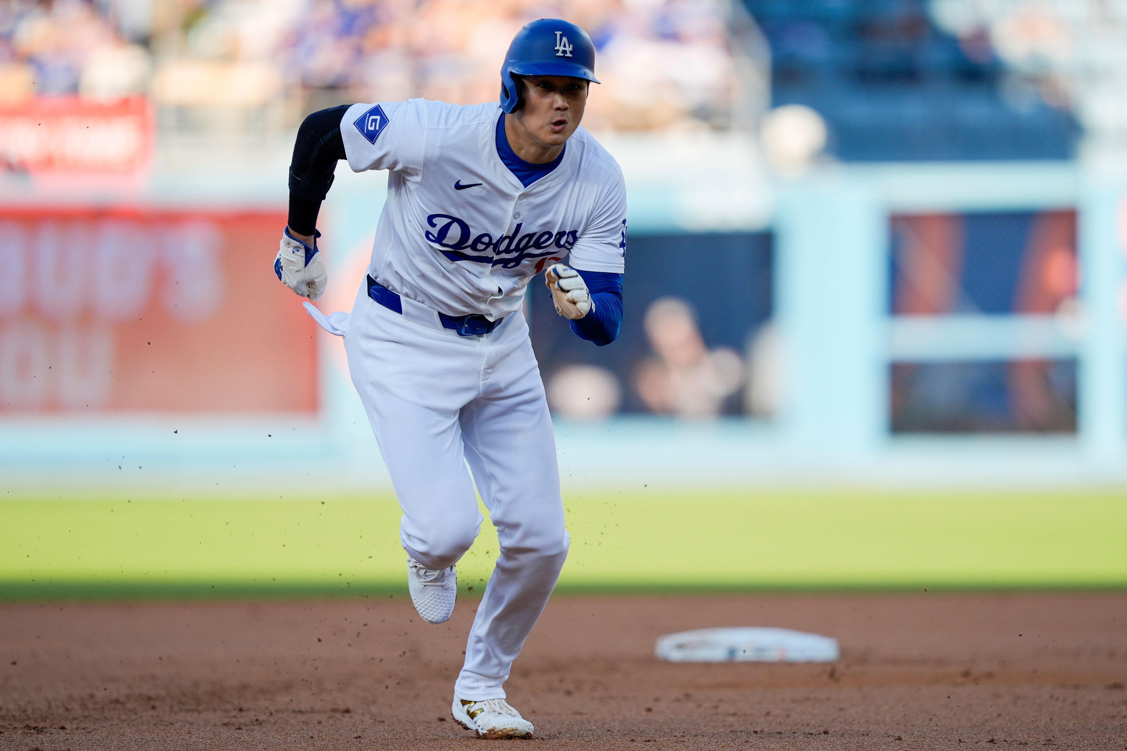 Los Angeles Dodgers designated hitter Shohei Ohtani steals third during the first inning of a baseball game against the Arizona Diamondbacks, Thursday, July 4, 2024, in Los Angeles. (AP Photo/Ryan Sun)