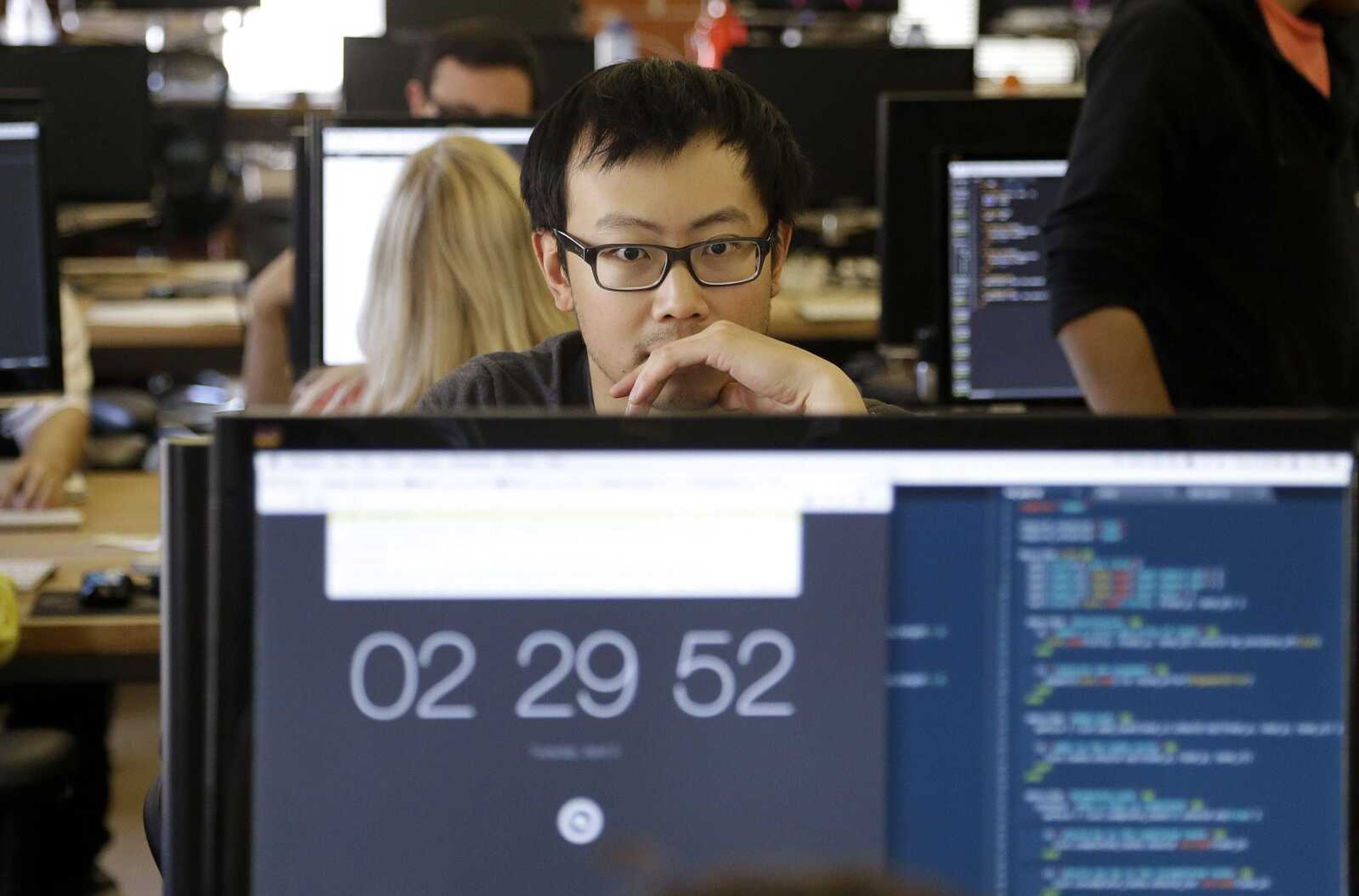 Student David Wen works during a class at Dev Bootcamp in San Francisco on April 2. Students are expected to work 80 to 100 hours a week writing code in teams with some experienced help. (Jeff Chiu ~ Associated Press)