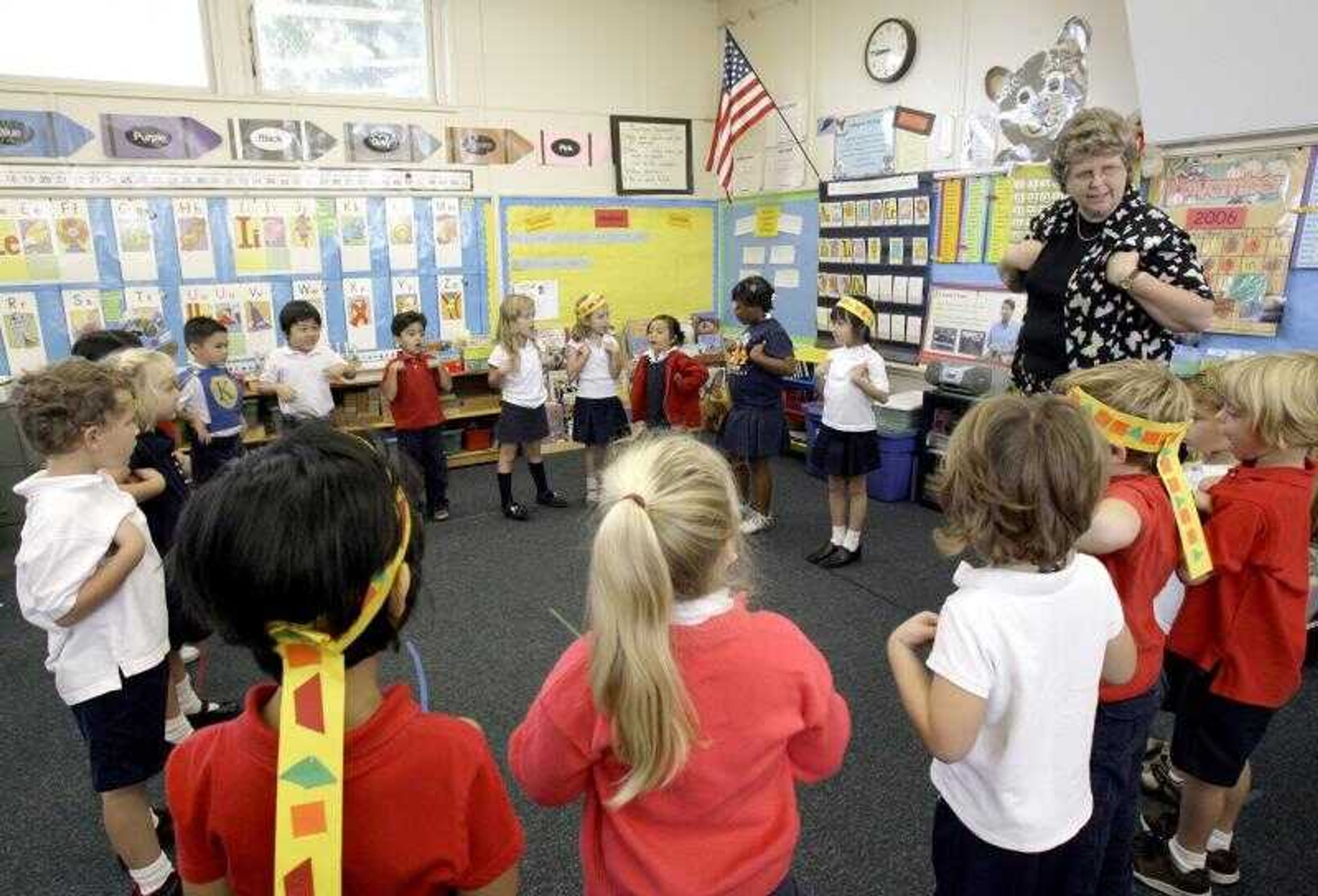 Becky Wyatt oversaw rehearsals at Kettering Elementary School in Long Beach, Calif., for the annual Thanksgiving play put on by her kindergarten class. For years, students in her class have not added feathers to their American Indian headbands because they are considered sacred objects in the American Indian culture. (NICK UT ~ Associated Press)