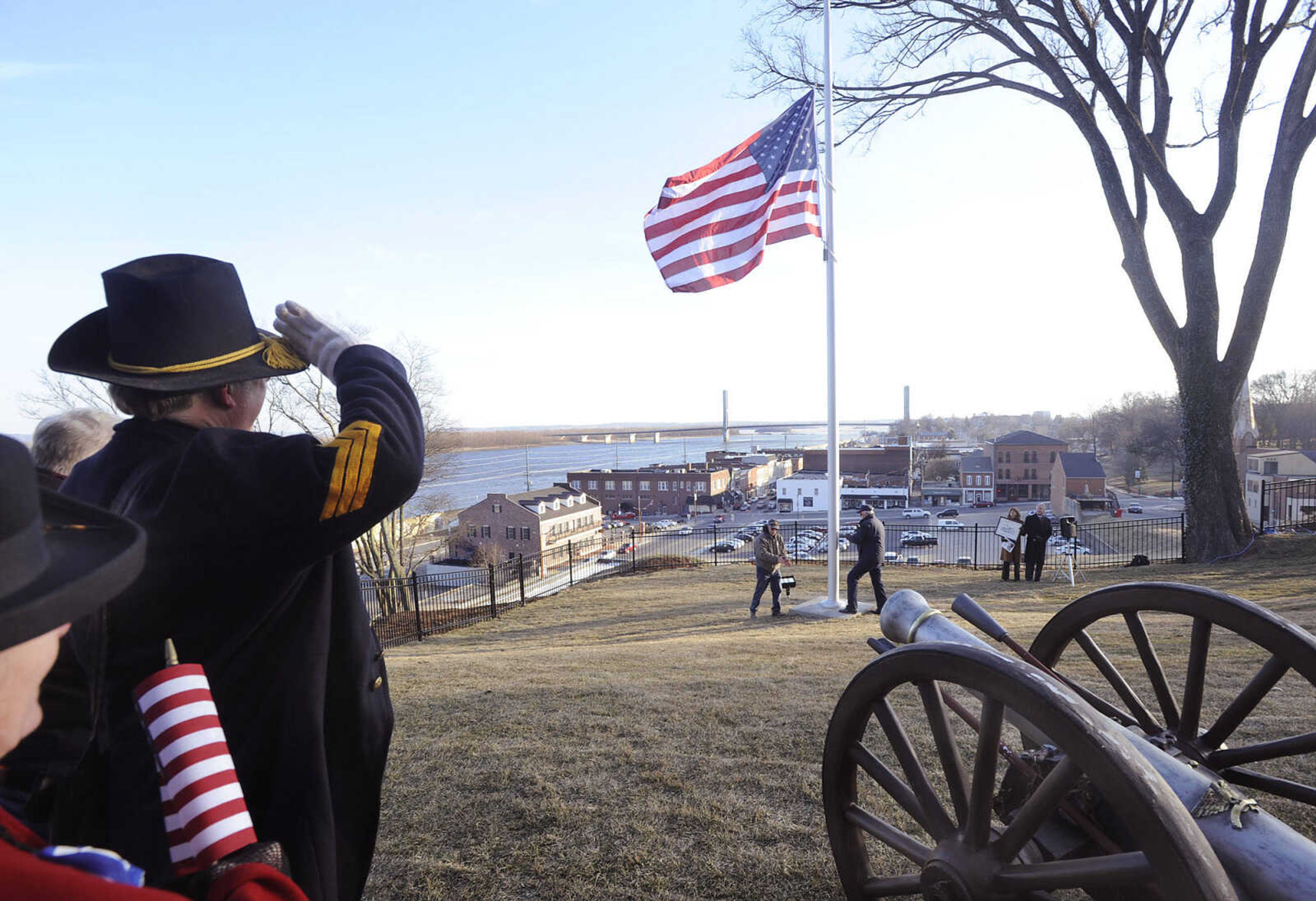 FRED LYNCH ~ flynch@semissourian.com
The Stars and Stripes is raised in a ceremony Friday, Feb. 13, 2015 presented by U.S. District Judge Stephen N. Limbaugh Jr. at the Civil War site of Fort A on the east end of Bellevue Street in Cape Girardeau. An apartment building at the site was recently razed after Limbaugh purchased the property situated above North Main Street. A fence has been installed and visitors will be able to view the Mississippi River from the site.