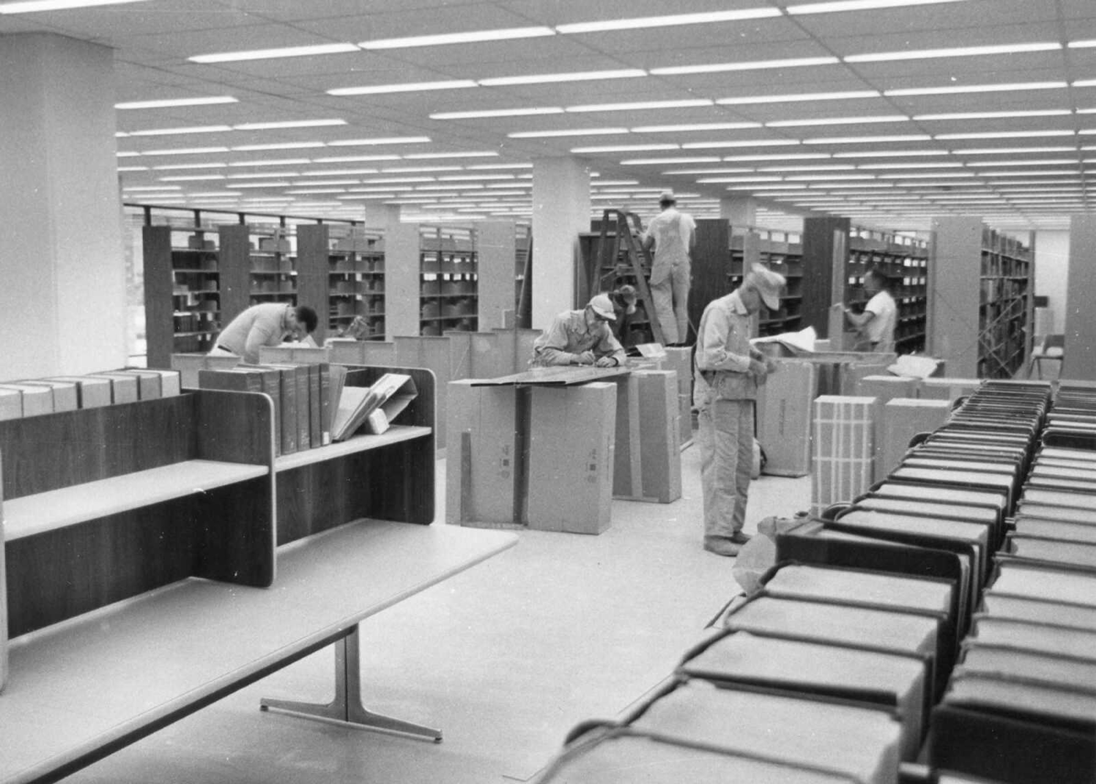 Published Nov. 4, 1967
It's moving time at Kent Library on the State College campus and workers are busy transferring books and equipment from the old building into the new addition. (Here workers) setting up stacks on the main floor of the new building are, from the left, Jesse Martin, Herbert Williams, Elvis Kirn and Jerome Hoffman... (Southeast Missourian archive photo)