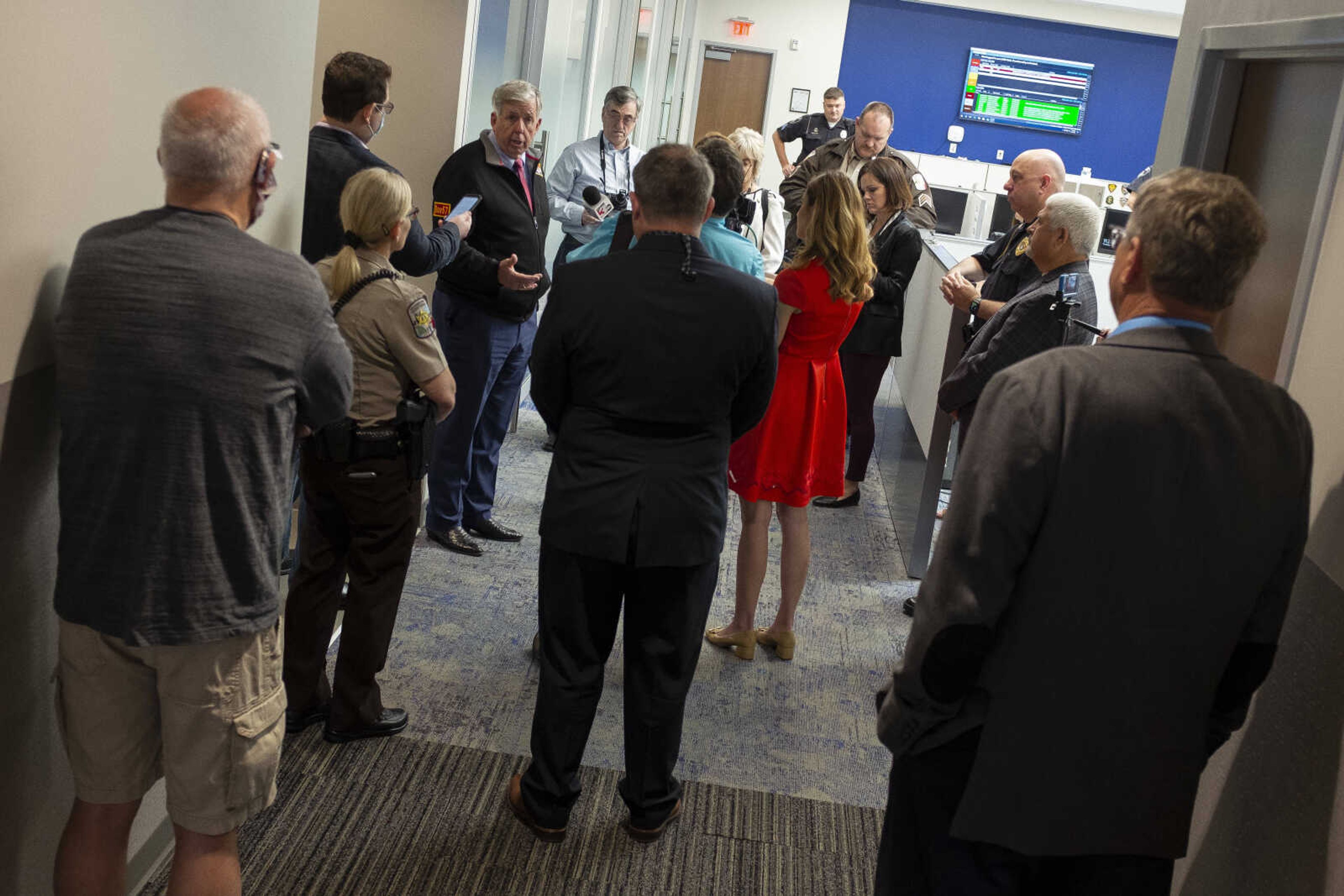 Missouri Gov. Mike Parson, at left center and facing camera, talks while making a visit Thursday, May 14, 2020, to the Cape Girardeau Police Department in Cape Girardeau.