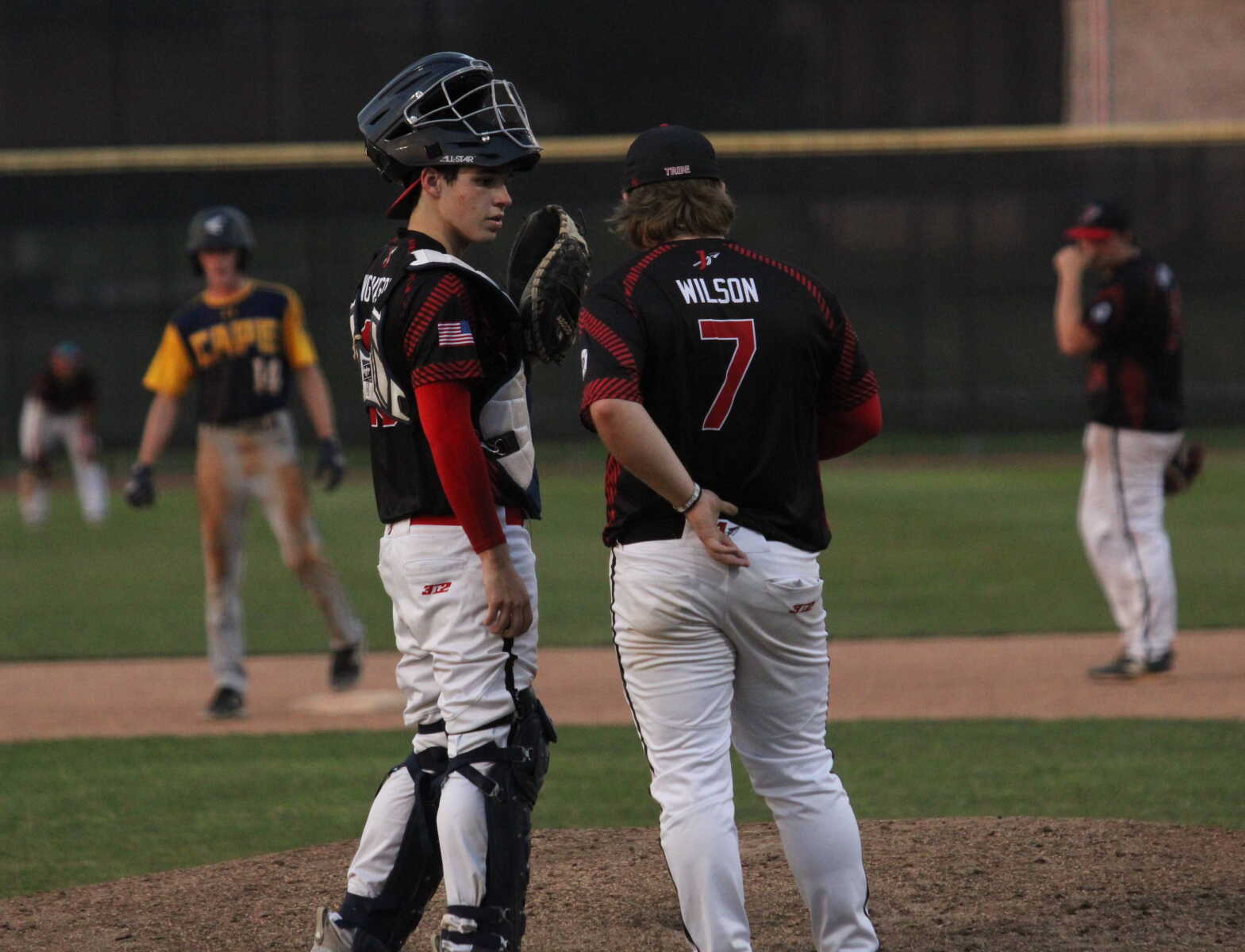 Tribe's Lance Wilson and Nathan Ingvalson have a mound visit during the June 19. game between Jackson and Cape Legion.